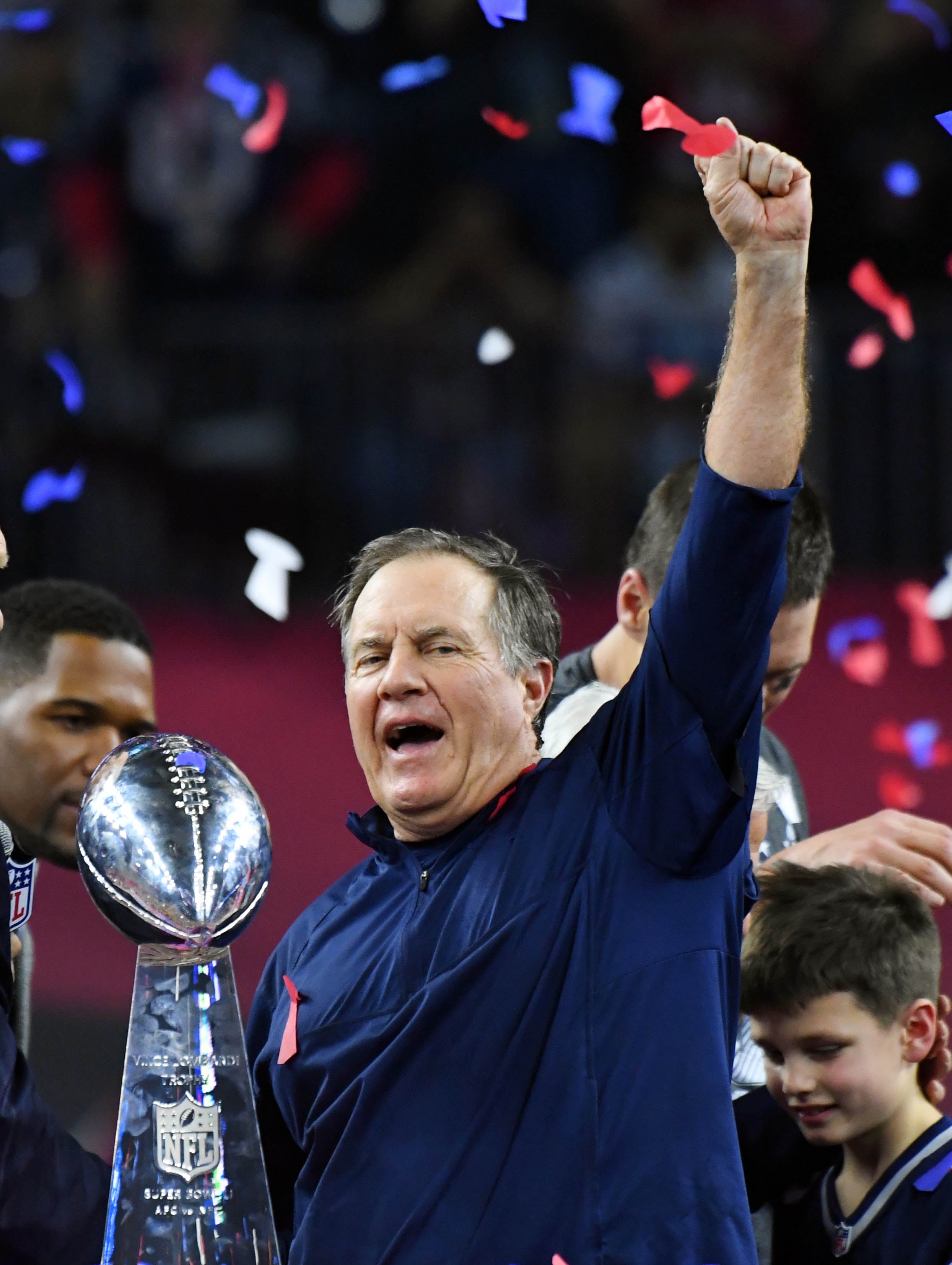 New England Patriots head coach Bill Belichick celebrates with the Vince Lombardi Trophy after defeating the Atlanta Falcons 34-38 in Super Bowl LI at NRG Stadium.