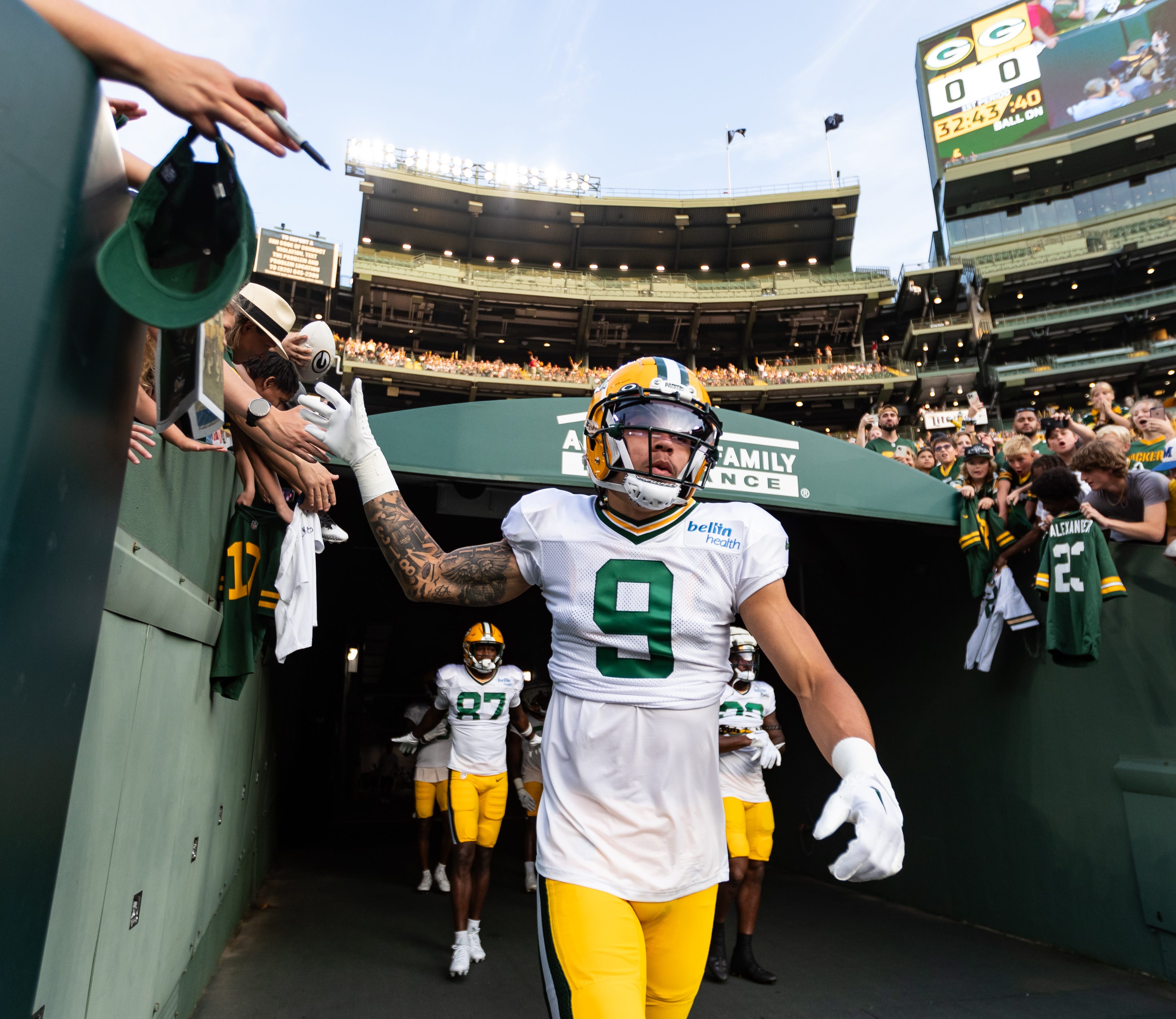 Green Bay Packers wide receiver Christian Watson (9) walks onto Lambeau Field at Packers Family Night on Saturday, August 5, 2023, in Green Bay, Wis.