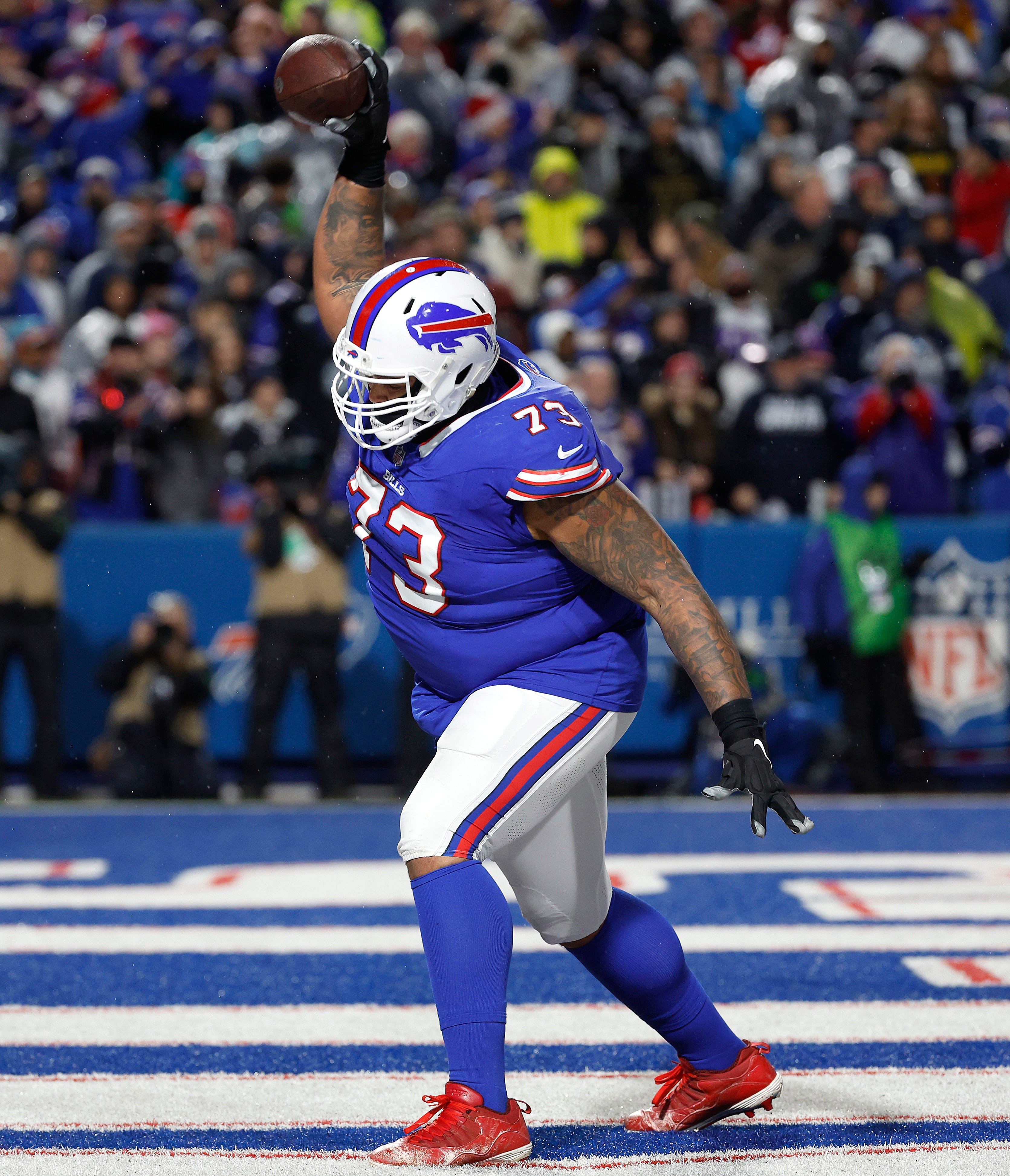 Buffalo Bills offensive tackle Dion Dawkins spikes the ball after a Josh Allen touchdown