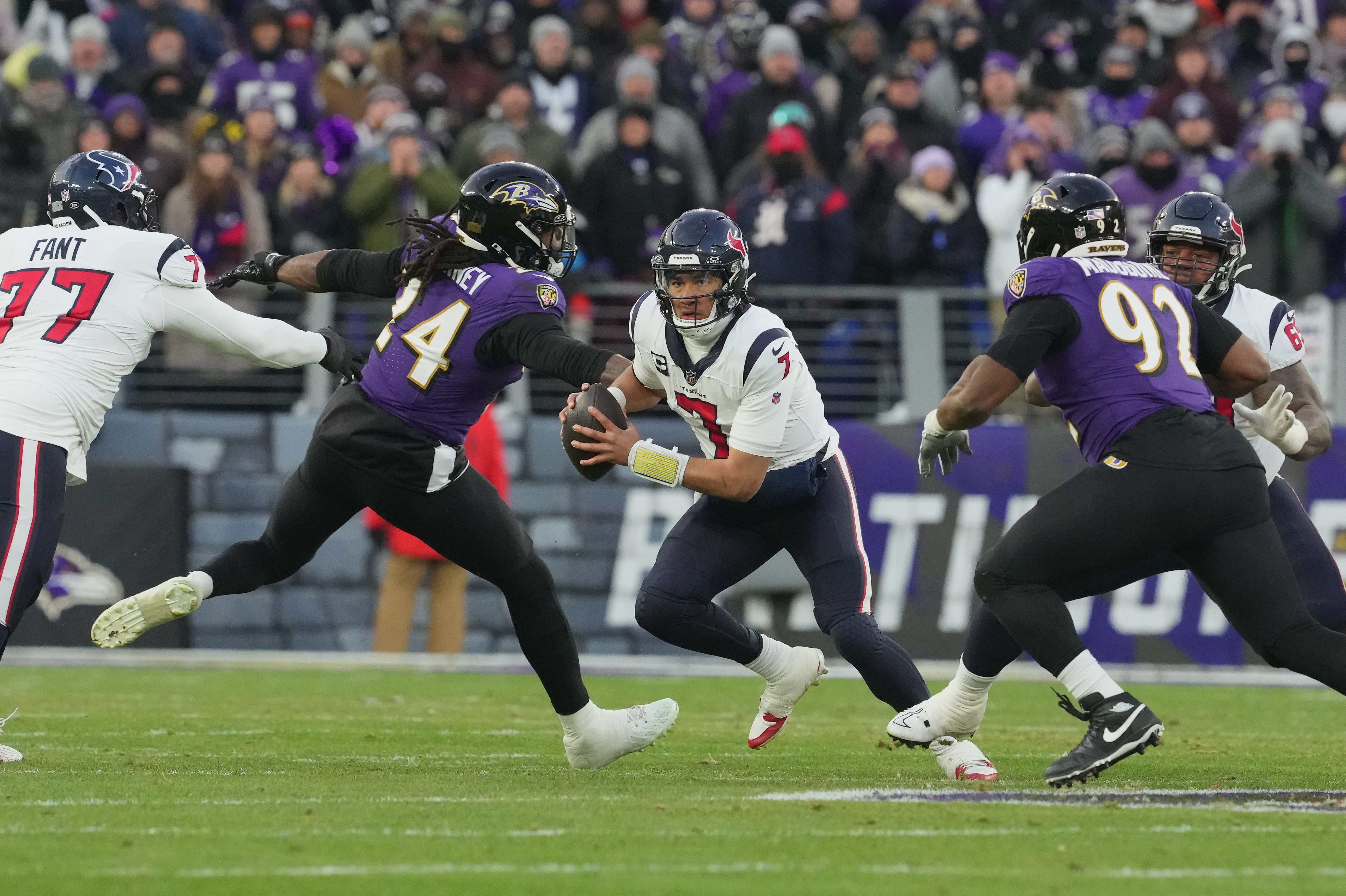 Jan 20, 2024; Baltimore, MD, USA; Houston Texans quarterback C.J. Stroud (7) runs the ball against Baltimore Ravens linebacker Jadeveon Clowney (24) and defensive tackle Justin Madubuike (92) during the first quarter of a 2024 AFC divisional round game at M&T Bank Stadium.