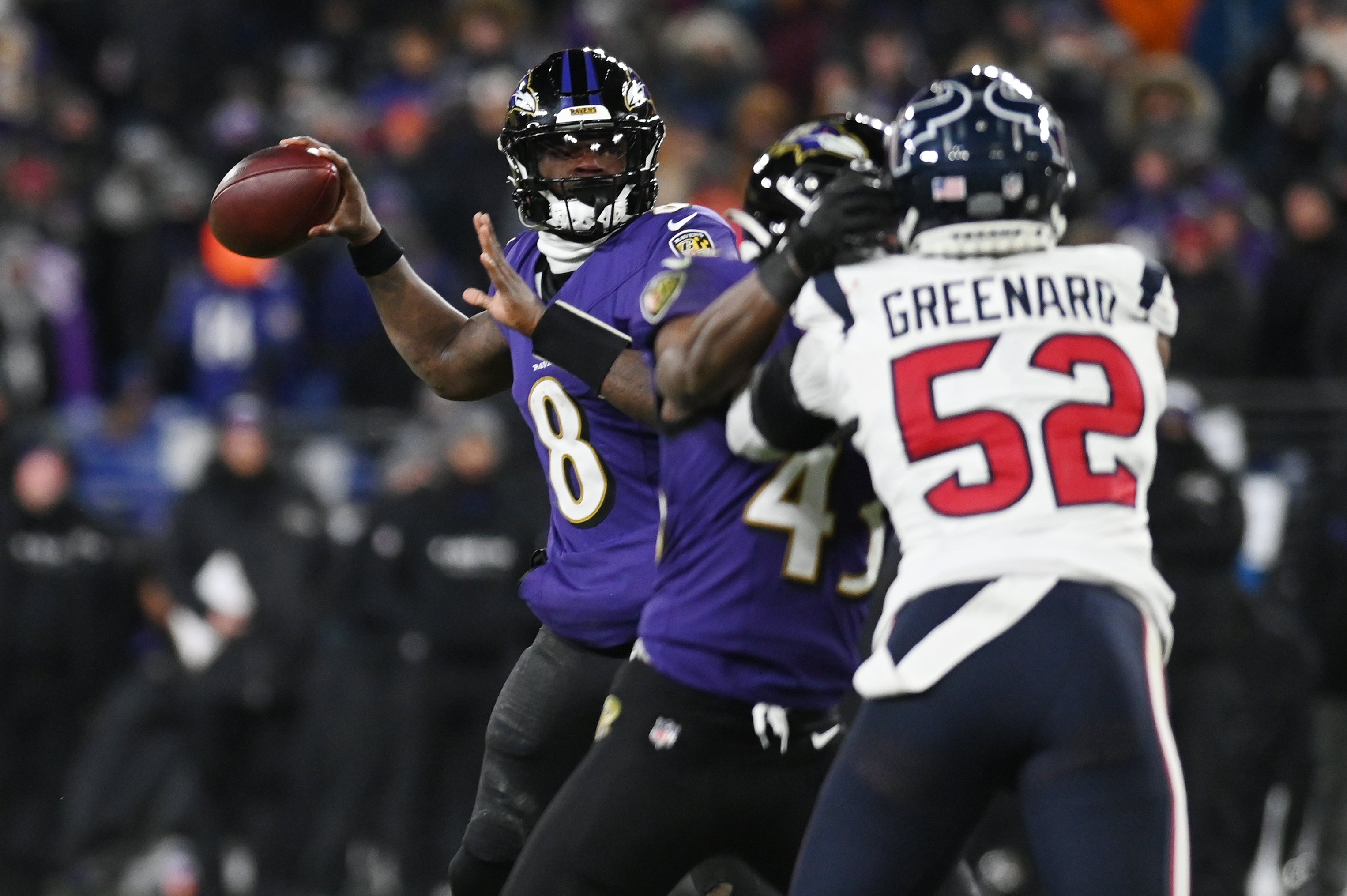 Baltimore Ravens quarterback Lamar Jackson (8) throws against the Houston Texans during the third quarter of a 2024 AFC divisional round game at M&T Bank Stadium.