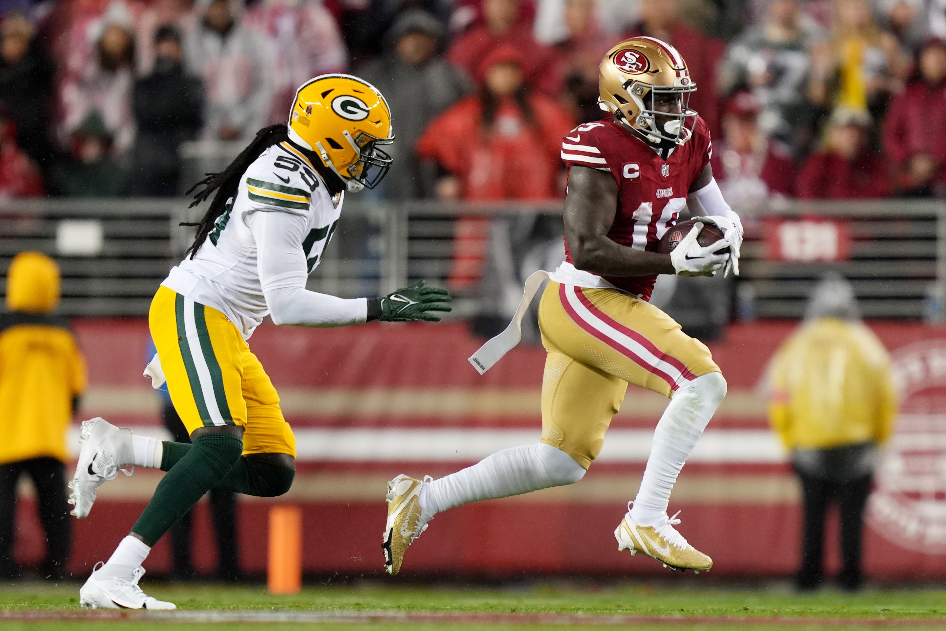 January 20, 2024; Santa Clara, CA, USA; San Francisco 49ers wide receiver Deebo Samuel (19) runs against Green Bay Packers linebacker De'Vondre Campbell (59) during the first quarter in a 2024 NFC divisional round game at Levi's Stadium.