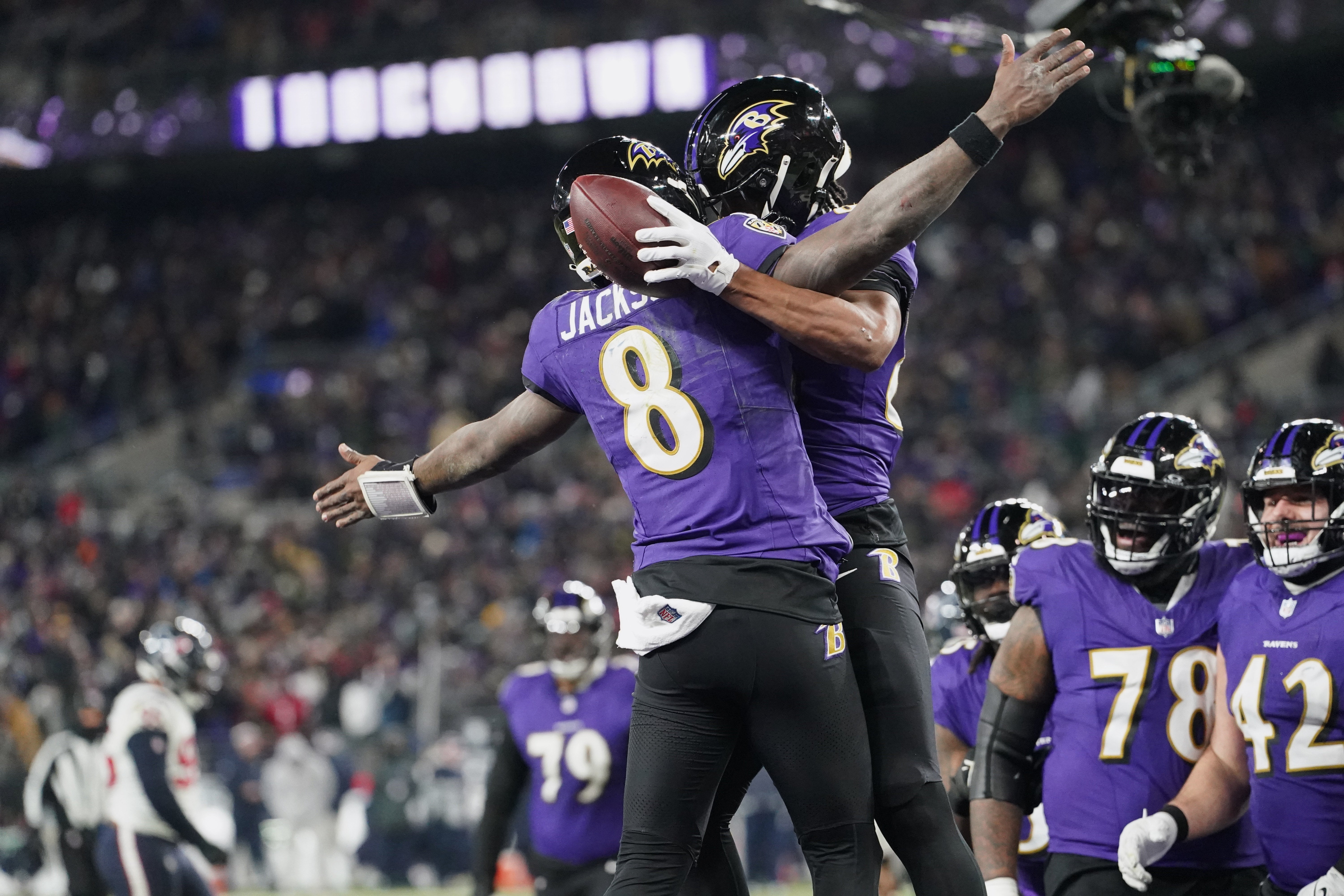 Jan 20, 2024; Baltimore, MD, USA; Baltimore Ravens tight end Isaiah Likely (80) celebrates with quarterback Lamar Jackson (8) after catching a pass for a touchdown against the Houston Texans during the fourth quarter of a 2024 AFC divisional round game at M&T Bank Stadium.