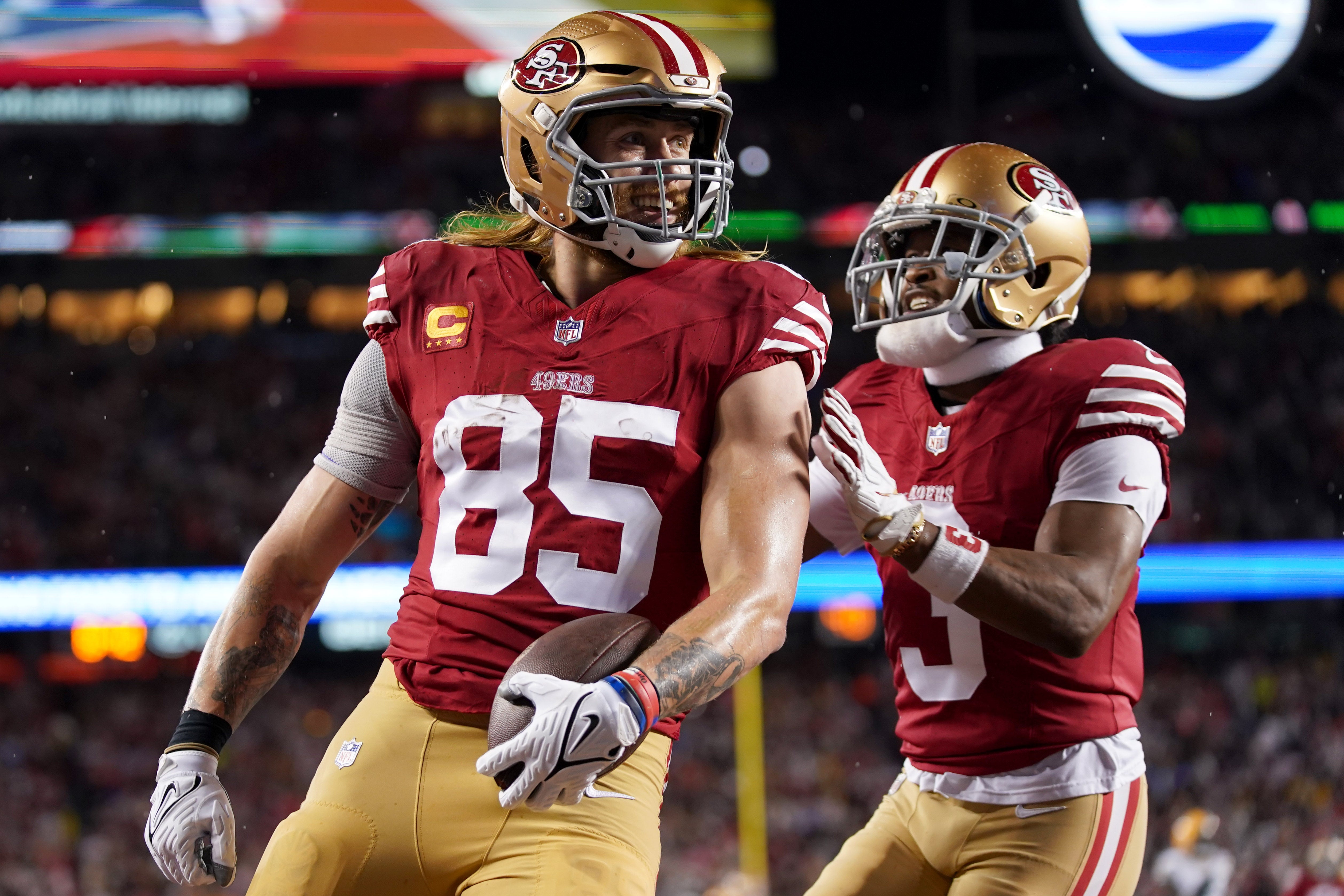 January 20, 2024; Santa Clara, CA, USA; San Francisco 49ers tight end George Kittle (85) celebrates with wide receiver Ray-Ray McCloud III (3) after scoring a touchdown against the Green Bay Packers during the second quarter in a 2024 NFC divisional round game at Levi's Stadium.