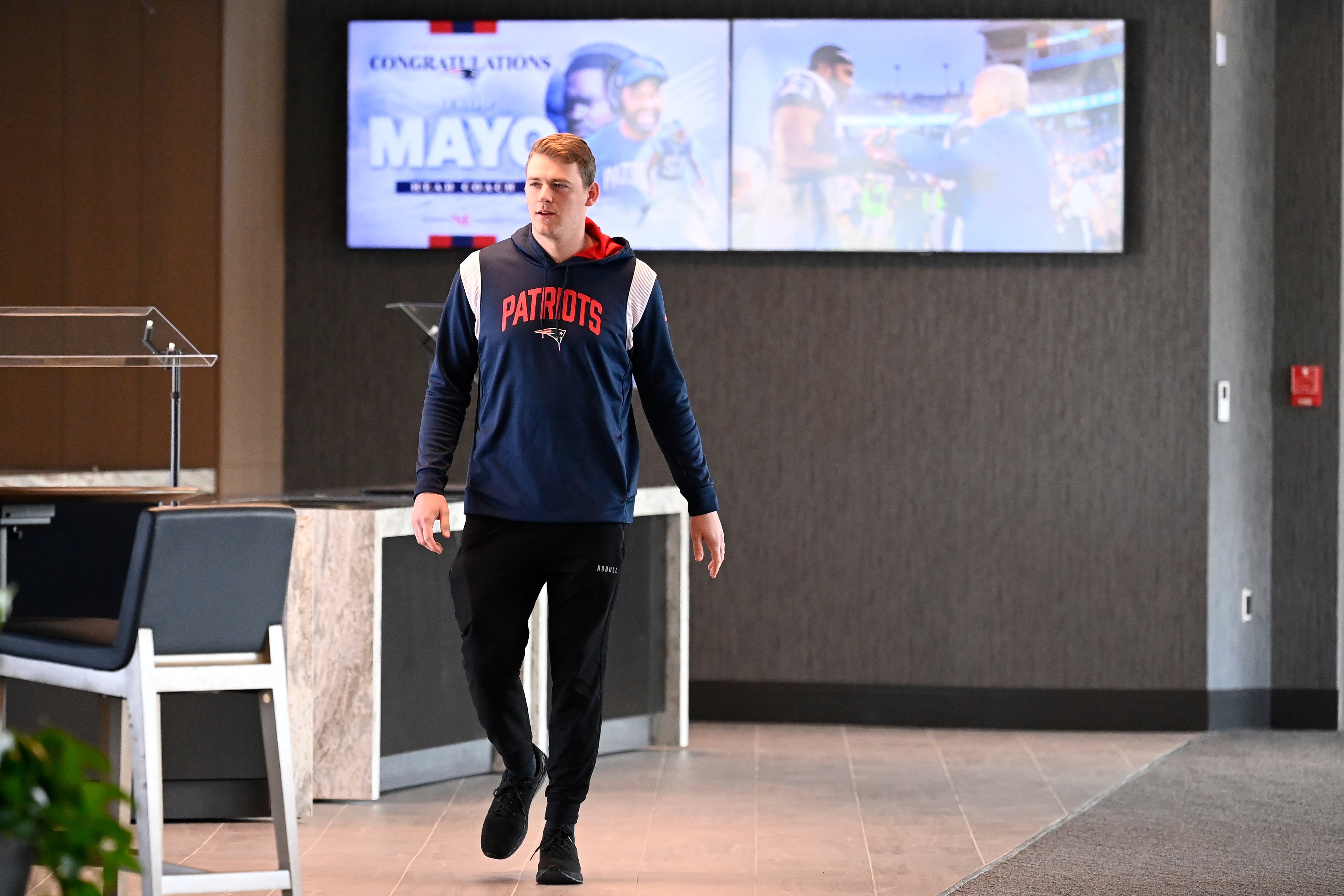 New England Patriots quarterback Mac Jones arrives to a press conference held at Gillette Stadium to announce the team's hiring of new head coach Jerod Mayo