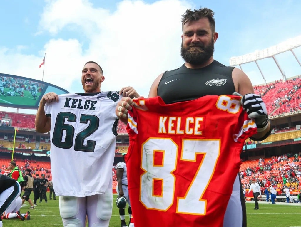 Kansas City Chiefs tight end Travis Kelce (87) and Philadelphia Eagles center Jason Kelce (62) swap jersey after the game at Arrowhead Stadium.
