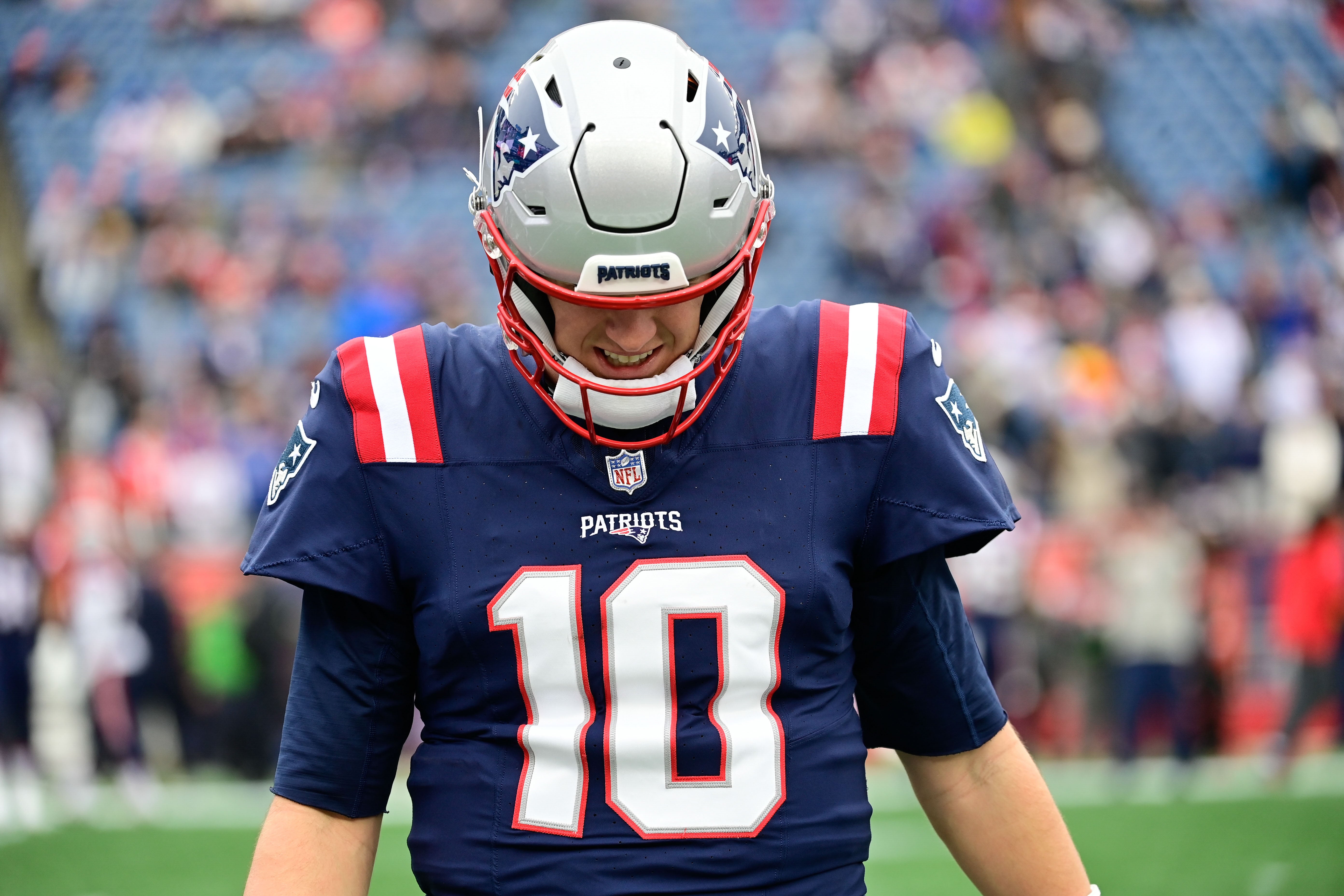 New England Patriots quarterback Mac Jones warms up before a game against the Kansas City Chiefs at Gillette Stadium.
