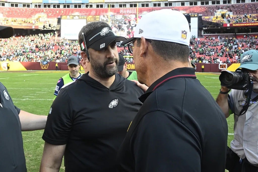Philadelphia Eagles head coach Nick Sirianni talks with Washington Commanders head coach Ron Rivera after the game at FedExField.