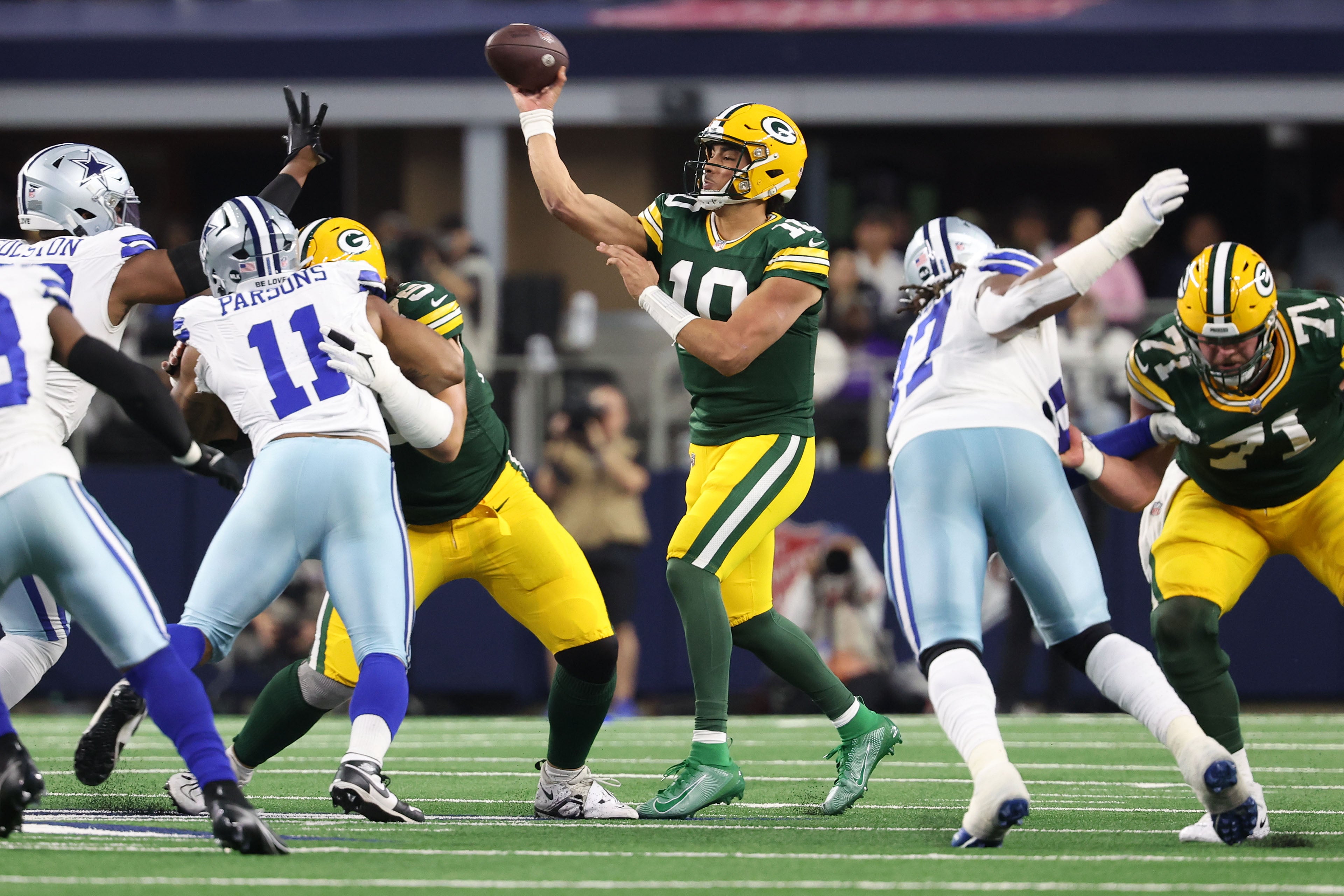 Green Bay Packers quarterback Jordan Love (10) drops back to pass against the Dallas Cowboys in the first half of the 2024 NFC wild card game at AT&T Stadium.