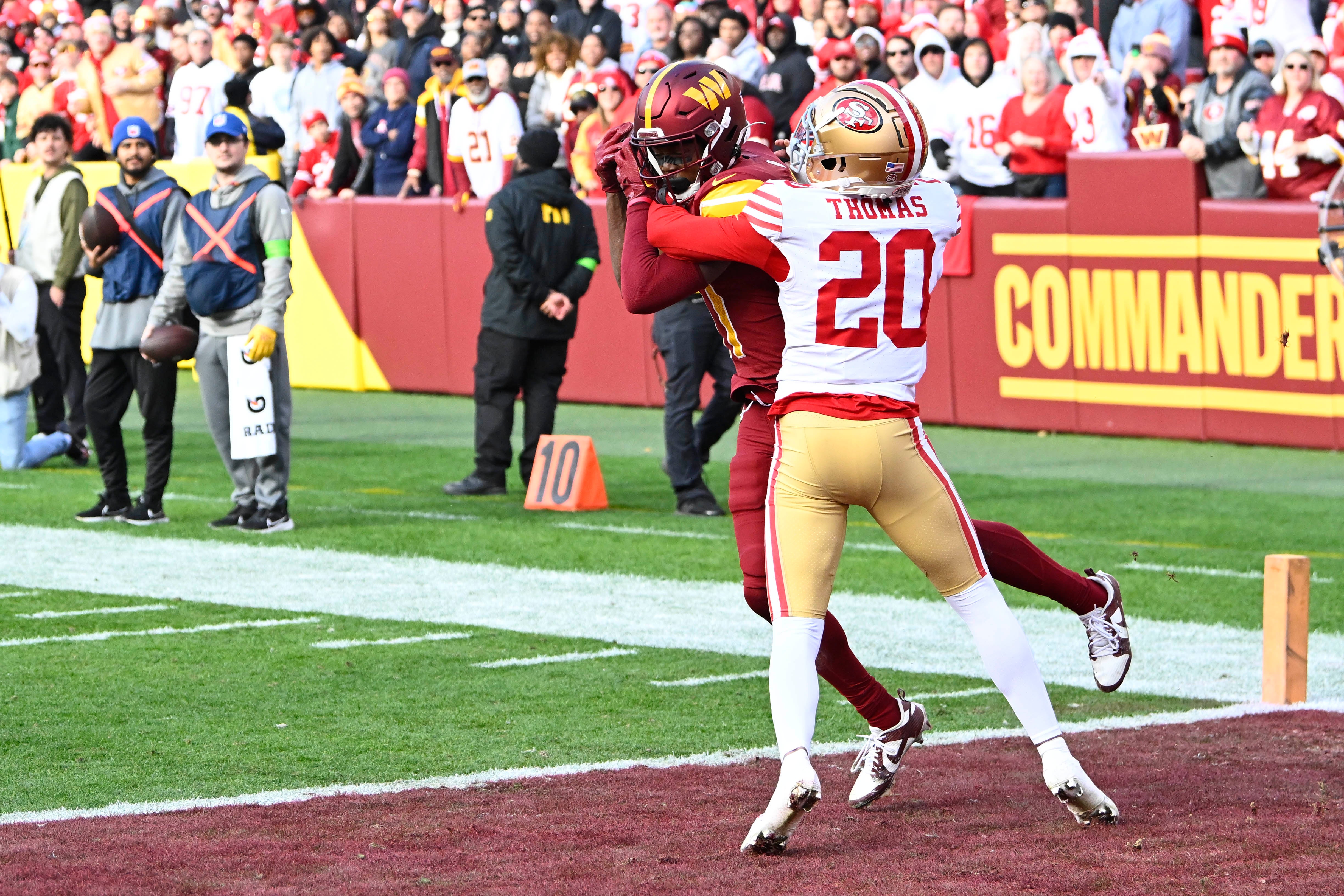 Dec 31, 2023; Landover, Maryland, USA; Washington Commanders wide receiver Terry McLaurin (17) catches a touchdown pass in front of San Francisco 49ers cornerback Ambry Thomas (20) during the first half at FedExField.