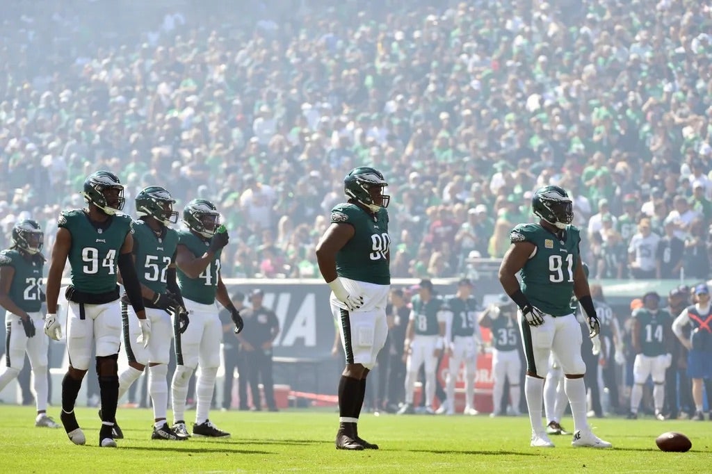 Philadelphia Eagles defensive end Josh Sweat (94), defensive tackle Jalen Carter (98) and defensive tackle Fletcher Cox (91) on field against the Washington Commanders at Lincoln Financial Field.