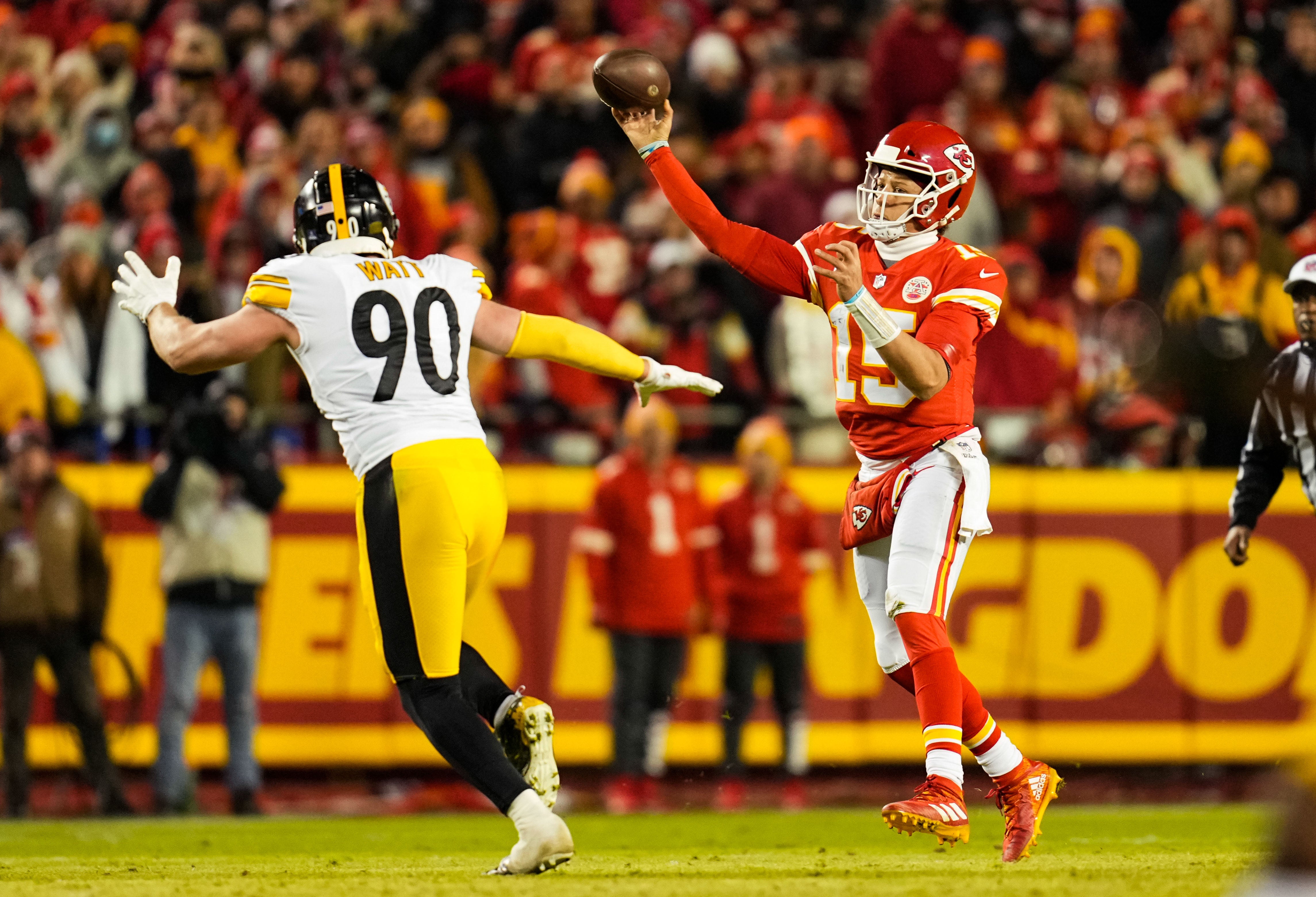 Jan 16, 2022; Kansas City, Missouri, USA; Kansas City Chiefs quarterback Patrick Mahomes (15) throws a pass as Pittsburgh Steelers outside linebacker T.J. Watt (90) defends during the first half in an AFC Wild Card playoff football game at GEHA Field at Arrowhead Stadium. Mandatory Credit: Jay Biggerstaff-USA TODAY Sports