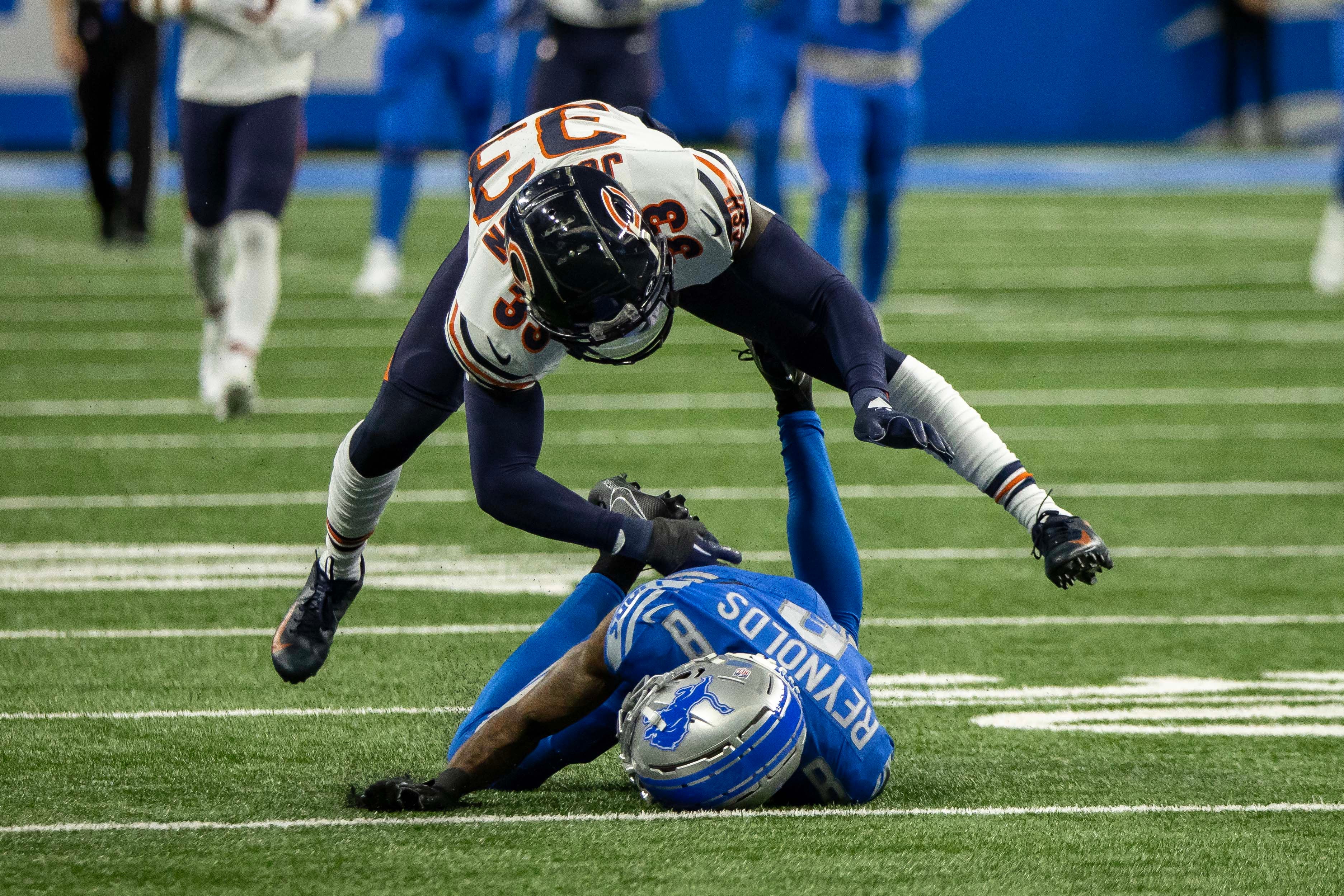 Nov 19, 2023; Detroit, Michigan, USA; Chicago Bears cornerback Jaylon Johnson (33) gets a pass interference call on Detroit Lions wide receiver Josh Reynolds (8) during the first half at Ford Field.