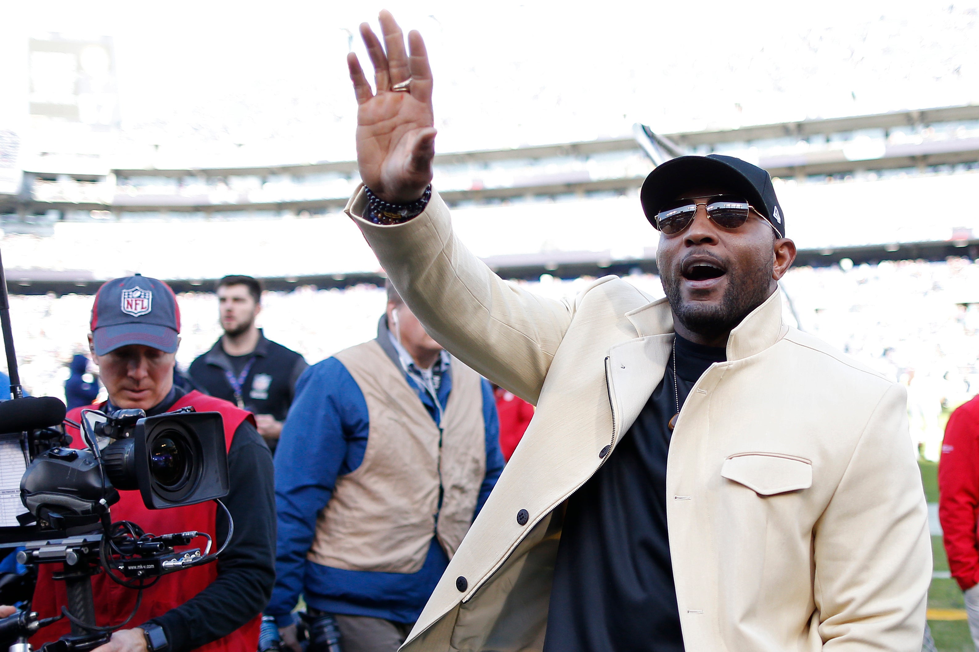 Pro football Hall of Famer and former Baltimore Ravens linebacker Ray Lewis waves to fans from the field during warm ups prior to the Ravens' game against the Los Angeles Chargers in a AFC Wild Card playoff football game at M&T Bank Stadium.