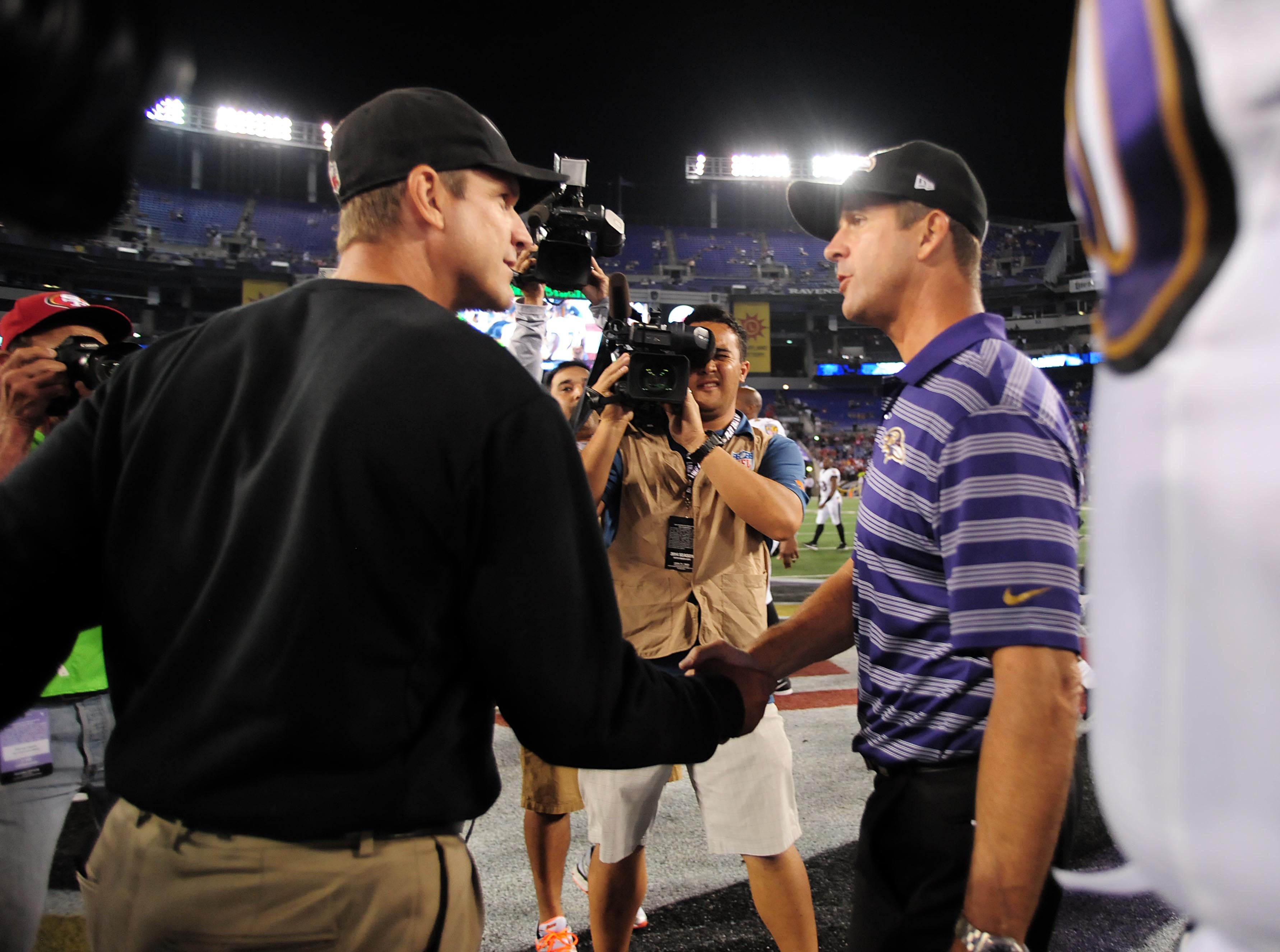 San Francisco 49ers head coach Jim Harbaugh (left) shakes hands with Baltimore Ravens head coach John Harbaugh (right) after the game at M&T Bank Stadium.