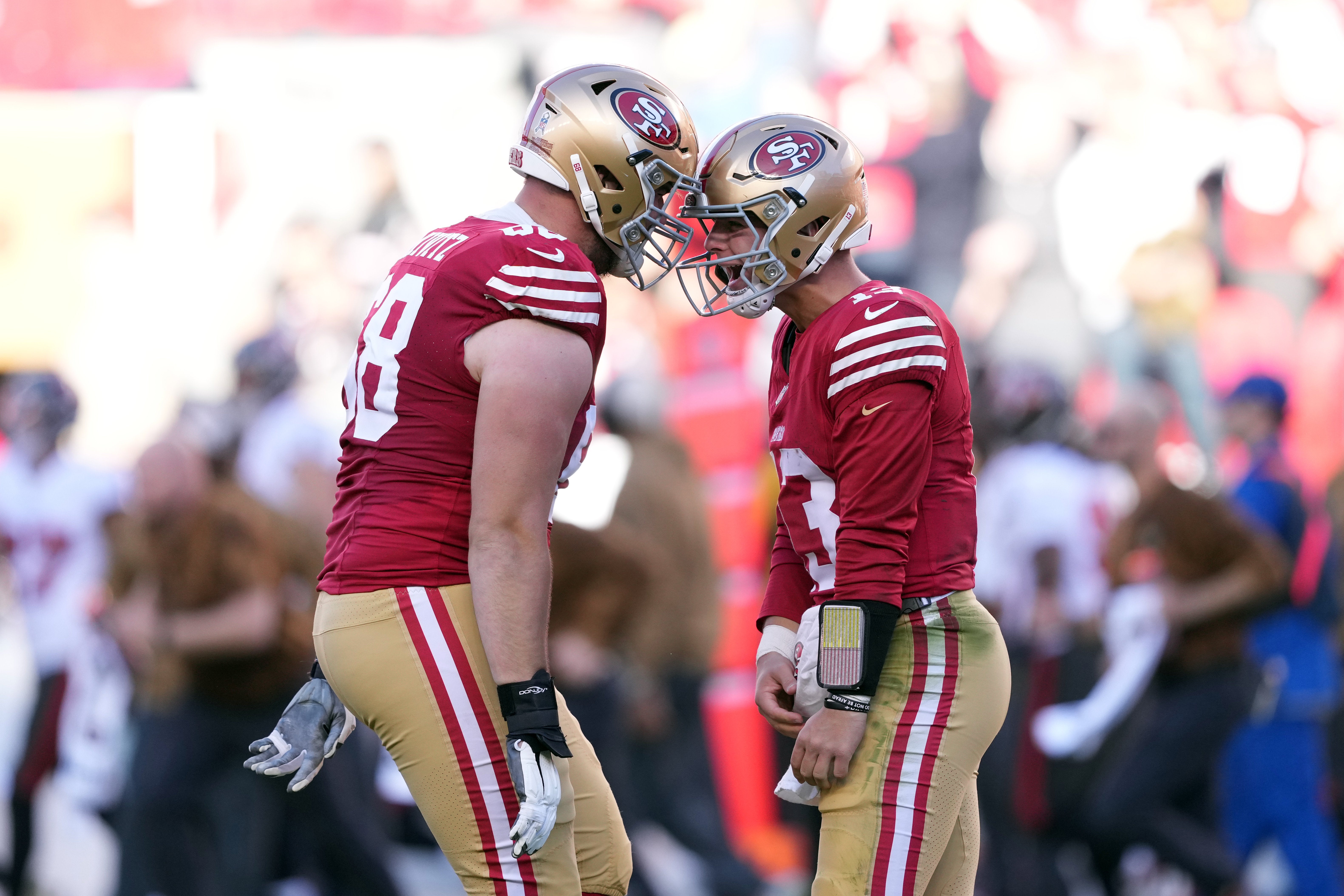 Nov 19, 2023; Santa Clara, California, USA; San Francisco 49ers quarterback Brock Purdy (right) celebrates with offensive tackle Colton McKivitz (left) after throwing a touchdown pass during the third quarter against the Tampa Bay Buccaneers at Levi's Stadium.