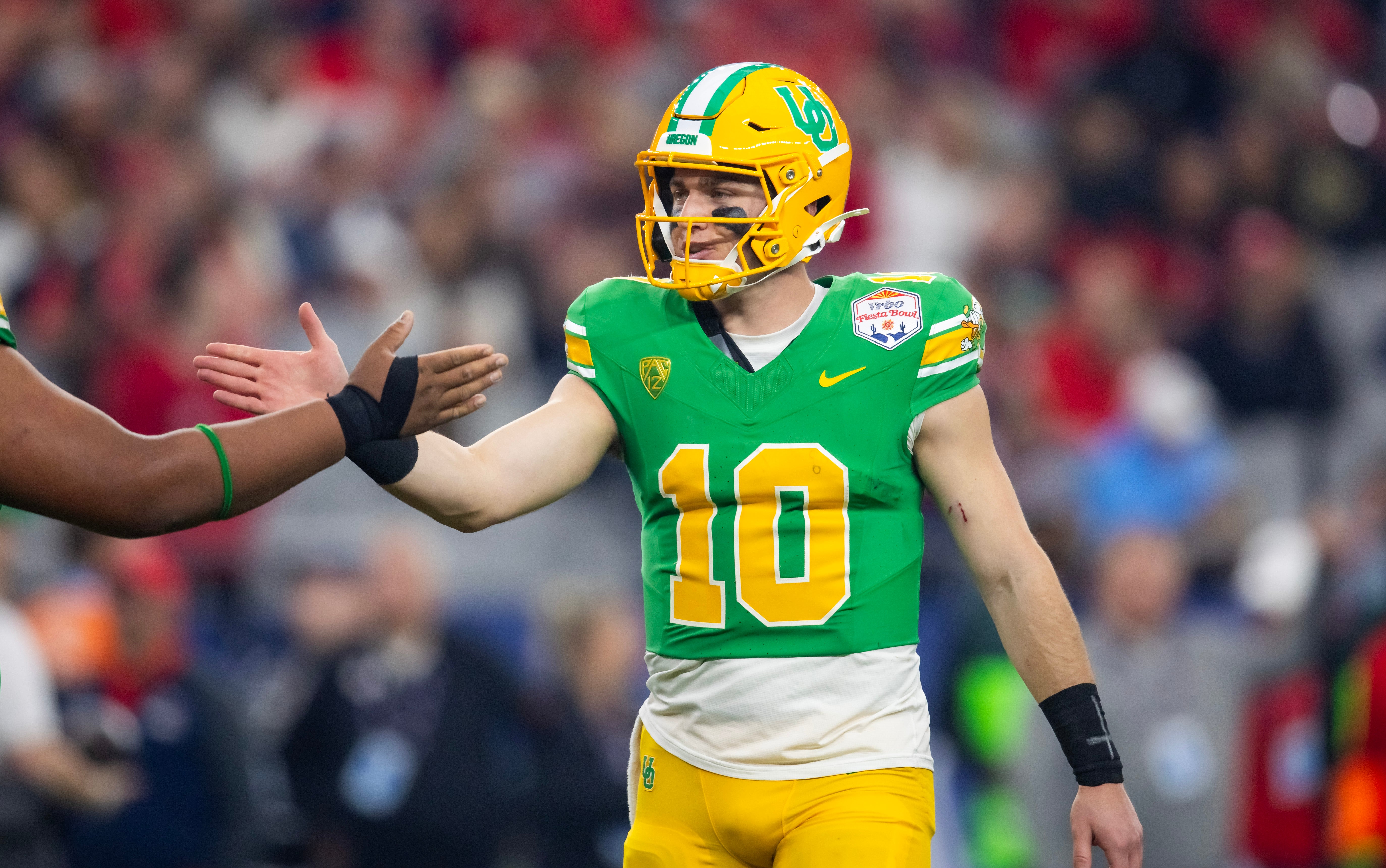 Jan 1, 2024; Glendale, AZ, USA; Oregon Ducks quarterback Bo Nix (10) celebrates against the Liberty Flames during the 2024 Fiesta Bowl at State Farm Stadium. Mandatory Credit: Mark J. Rebilas-USA TODAY Sports