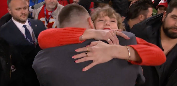 Taylor Swift and Travis Kelce hug after the Chiefs win the AFC Championship