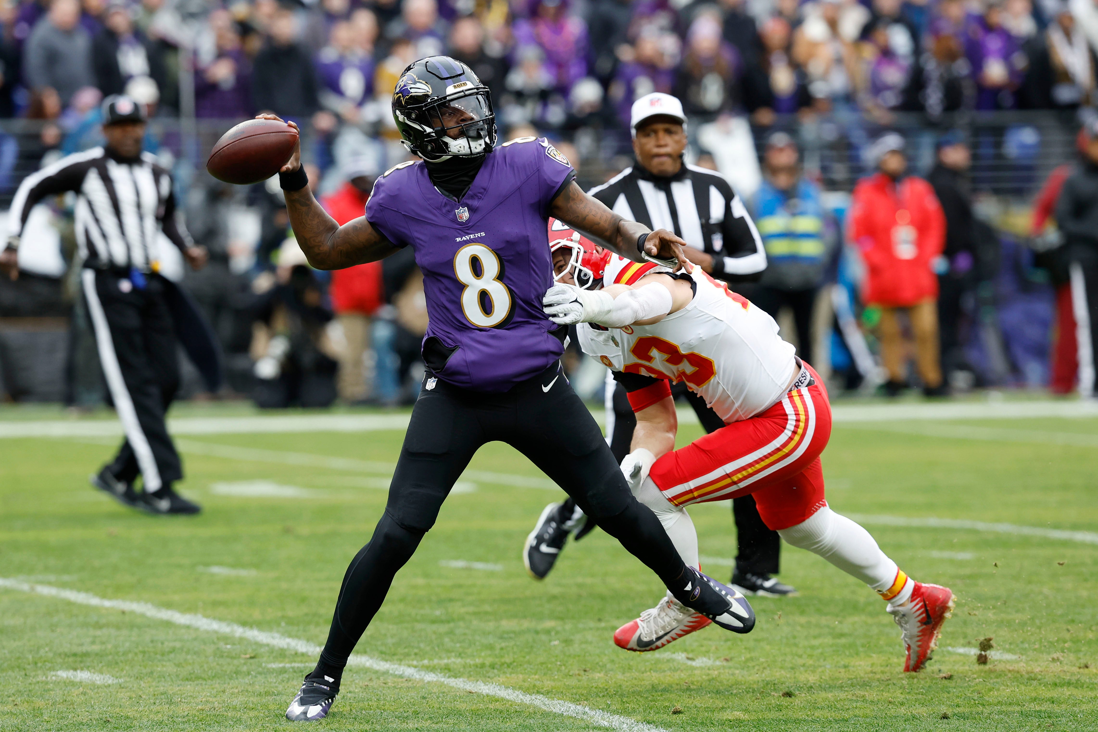 Baltimore Ravens quarterback Lamar Jackson (8) throws the ball as Kansas City Chiefs linebacker Drue Tranquill (23) defends during the first half in the AFC Championship football game at M&T Bank Stadium.