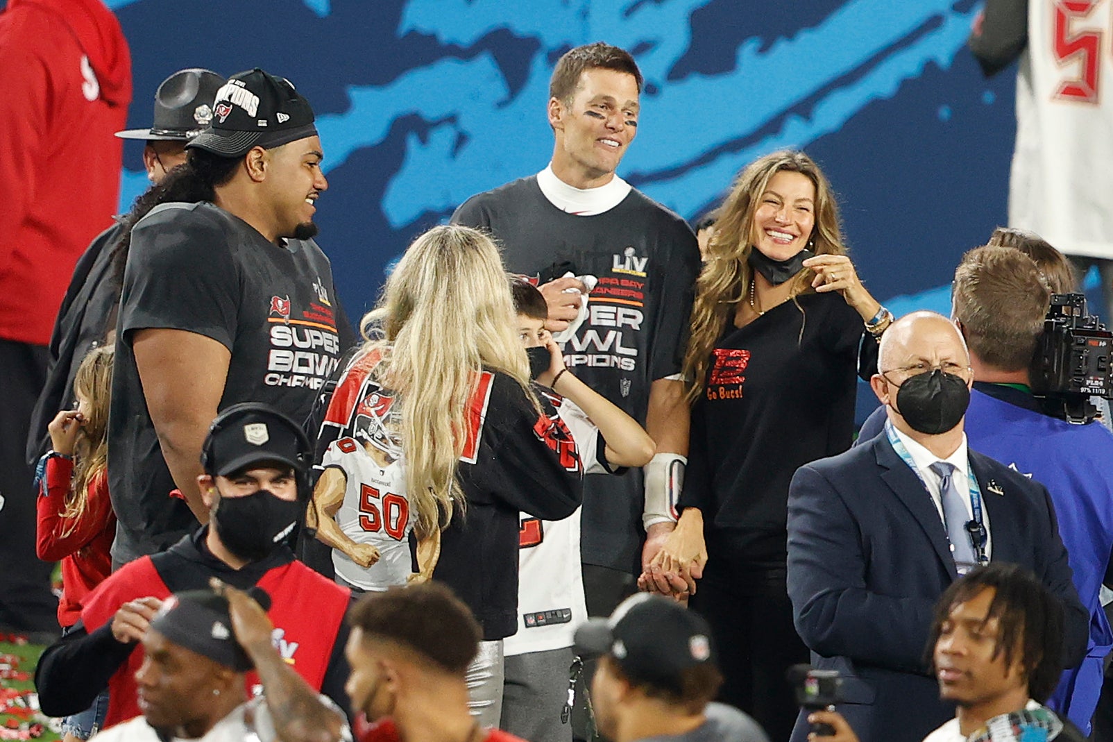 Tampa Bay Buccaneers quarterback Tom Brady celebrates with teammates and family after Super Bowl LV at Raymond James Stadium.
