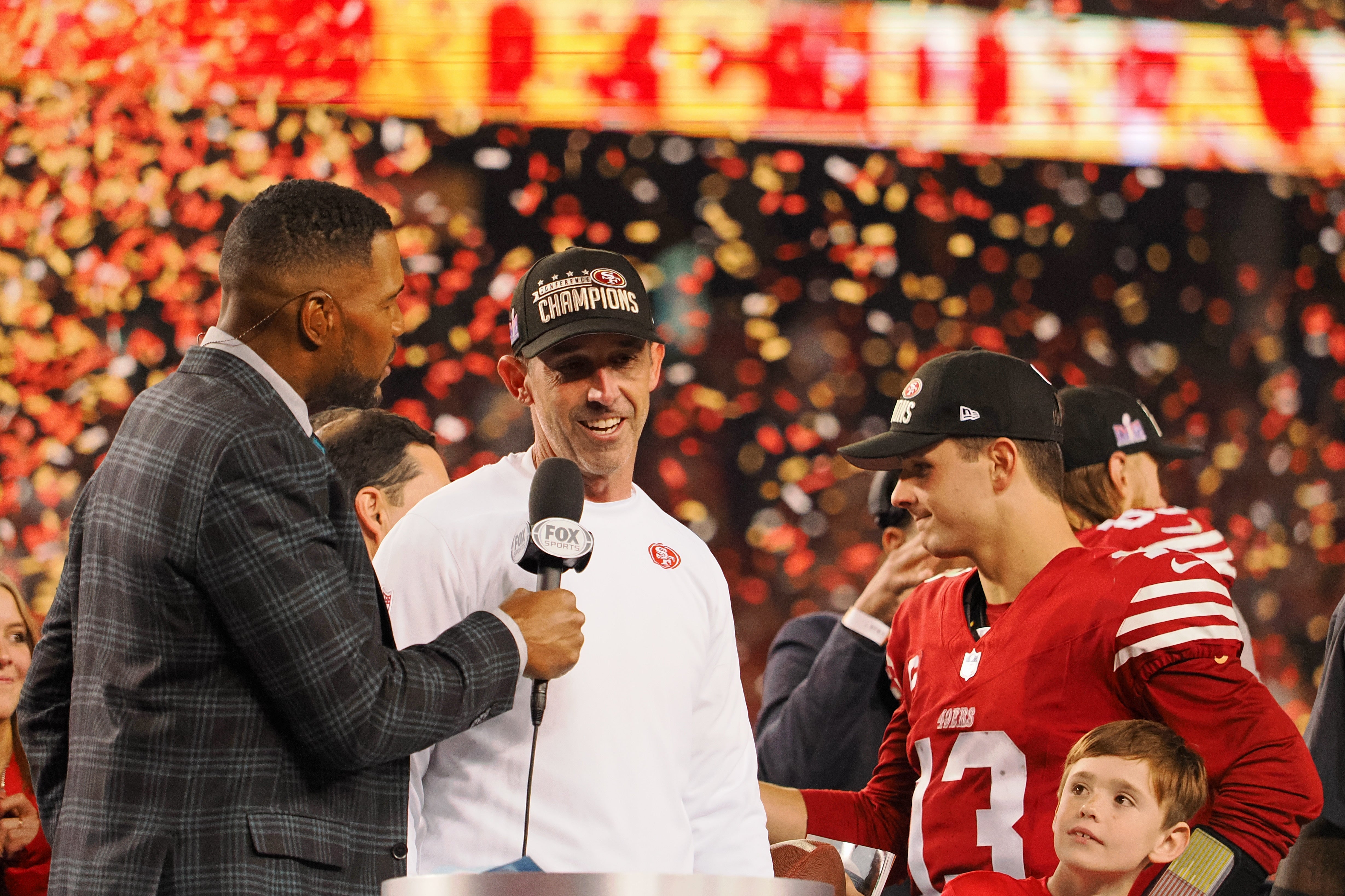 Jan 28, 2024; Santa Clara, California, USA; Fox Sports broadcaster and former NFL player Michael Strahan interviews San Francisco 49ers head coach Kyle Shanahan after winning the NFC Championship football game against the Detroit Lions at Levi's Stadium.Kelley L Cox-USA TODAY Sports