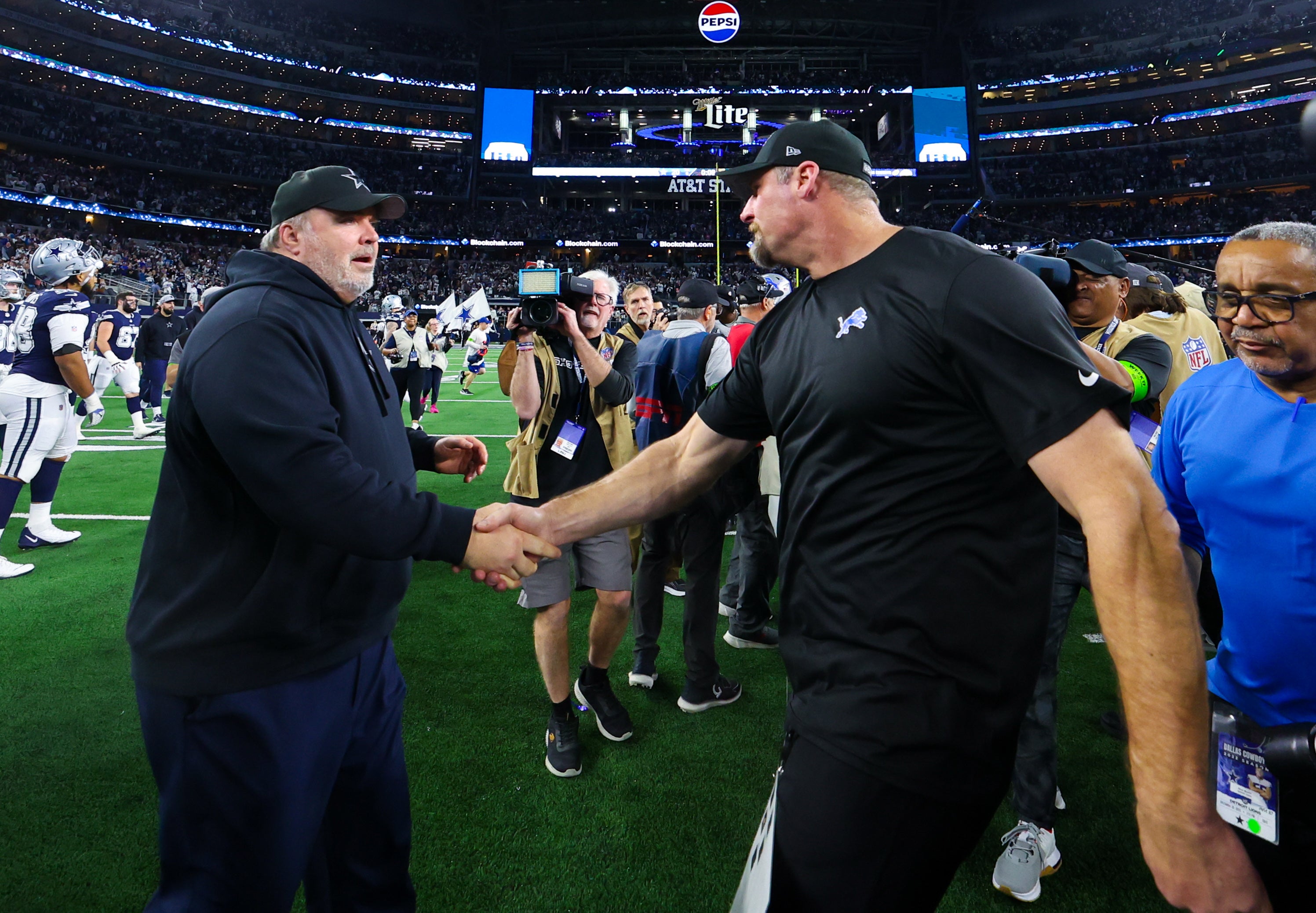Dallas Cowboys head coach Mike McCarthy shakes hands with Detroit Lions head coach Dan Campbell after the game at AT&T Stadium.