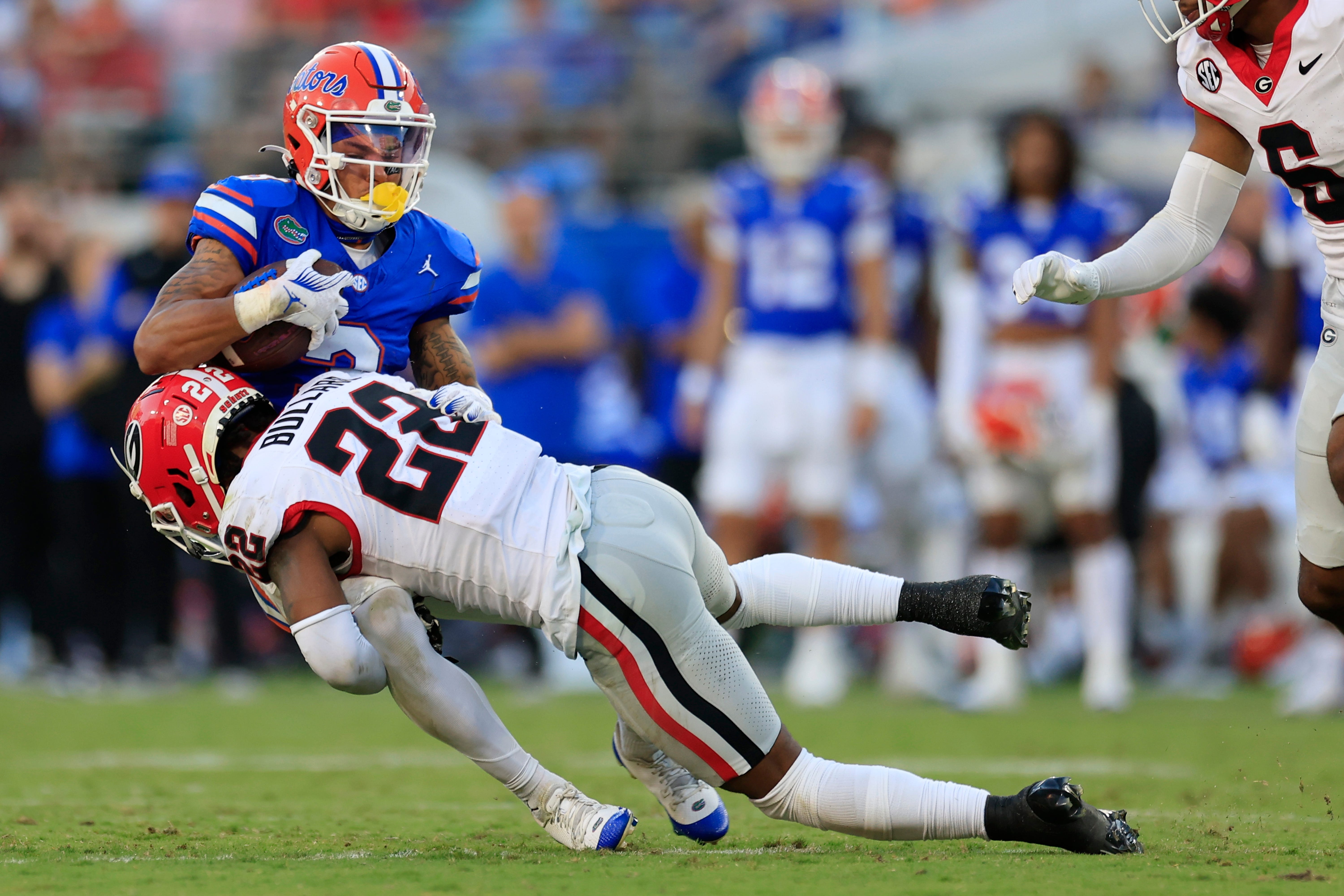 Georgia Bulldogs defensive back Javon Bullard (22) tackles Florida Gators wide receiver Eugene Wilson III (3) during the third quarter of an NCAA Football game Saturday, Oct. 28, 2023 at EverBank Stadium in Jacksonville, Fla. Georgia defeated Florida 43-20. [Corey Perrine/Florida Times-Union]