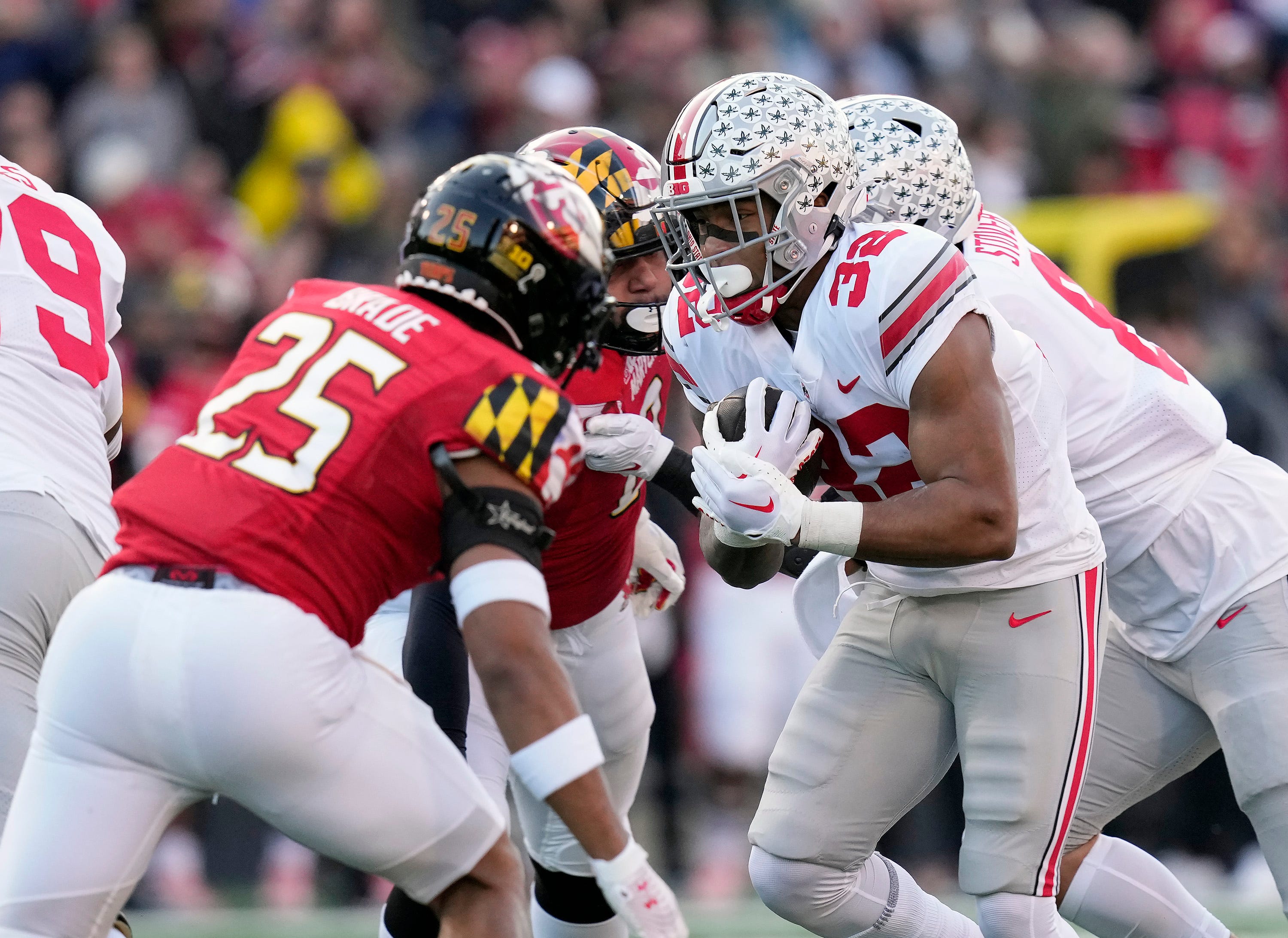 Nov 19, 2022; College Park, MD, USA; Ohio State Buckeyes running back TreVeyon Henderson (32) carries the ball against Maryland Terrapins defensive back Beau Brade (25) in the first quarter of their Big Ten game at SECU Stadium. Ceb Osu22mar Kwr 18