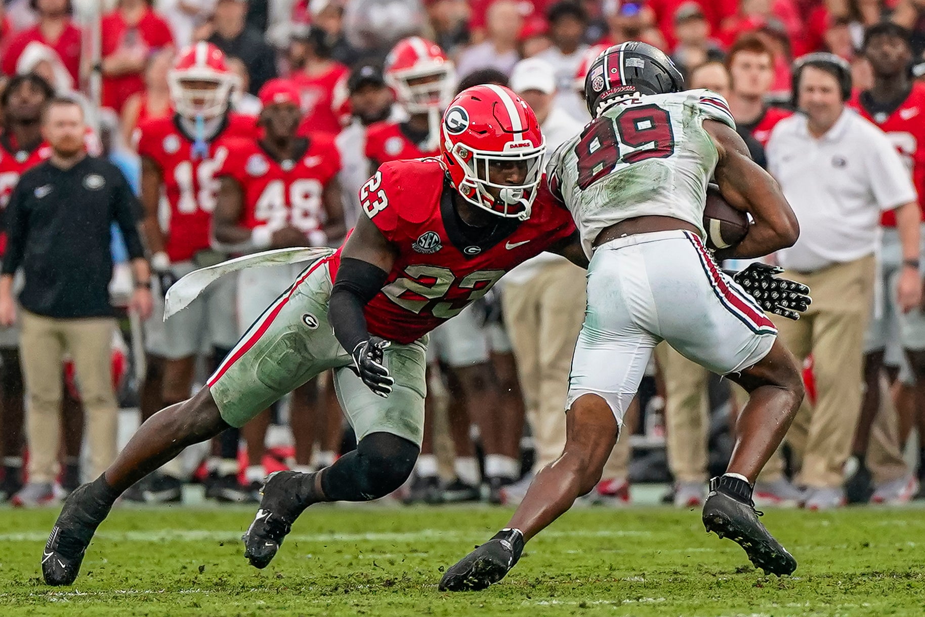 Sep 16, 2023; Athens, Georgia, USA; Georgia Bulldogs defensive back Tykee Smith (23) tackles South Carolina Gamecocks wide receiver O'Mega Blake (89) during the second half at Sanford Stadium. Mandatory Credit: Dale Zanine-USA TODAY Sports