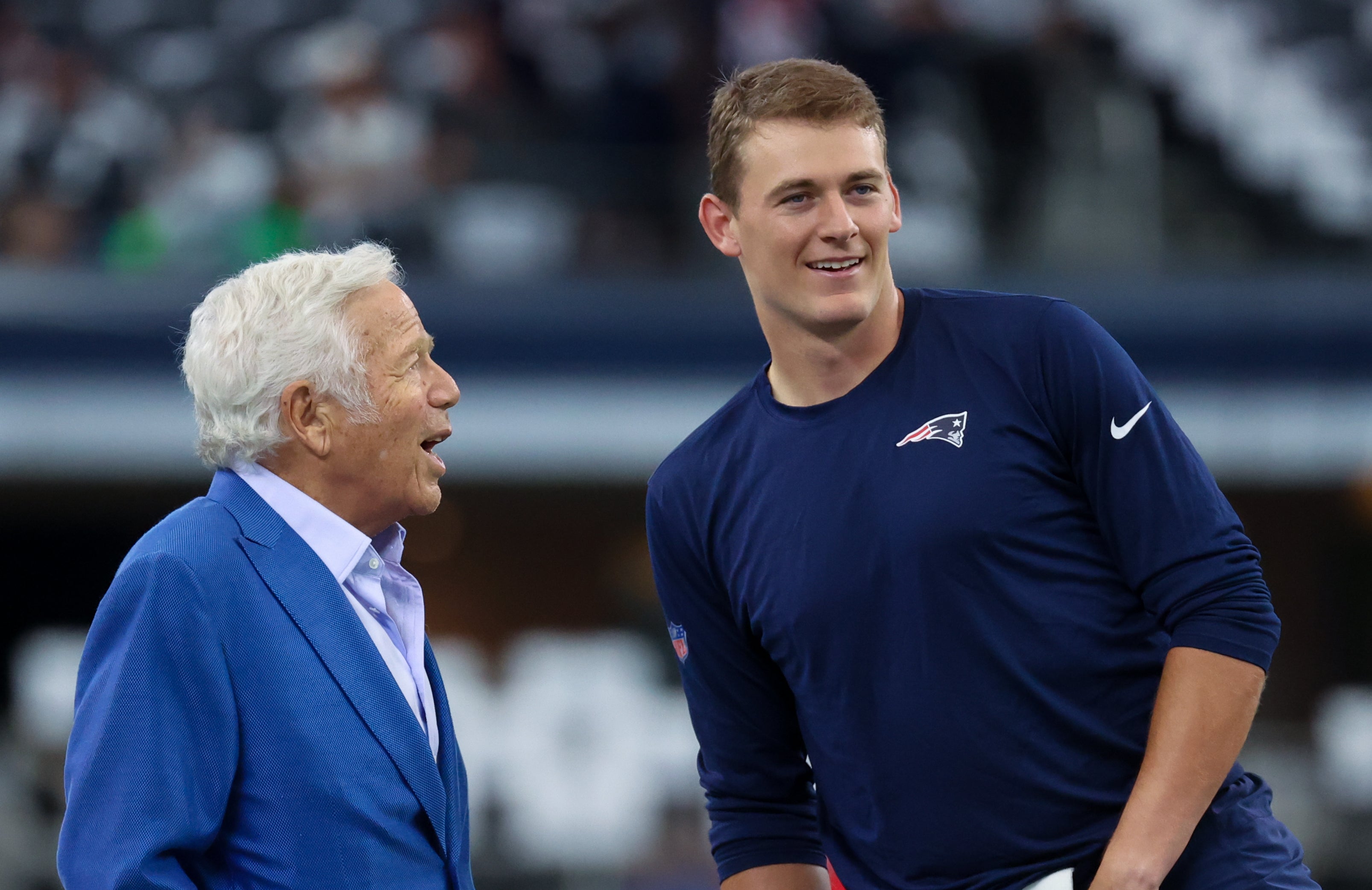 New England Patriots owner Robert Kraft speaks with New England Patriots quarterback Mac Jones before the game against the Dallas Cowboys at AT&T Stadium.