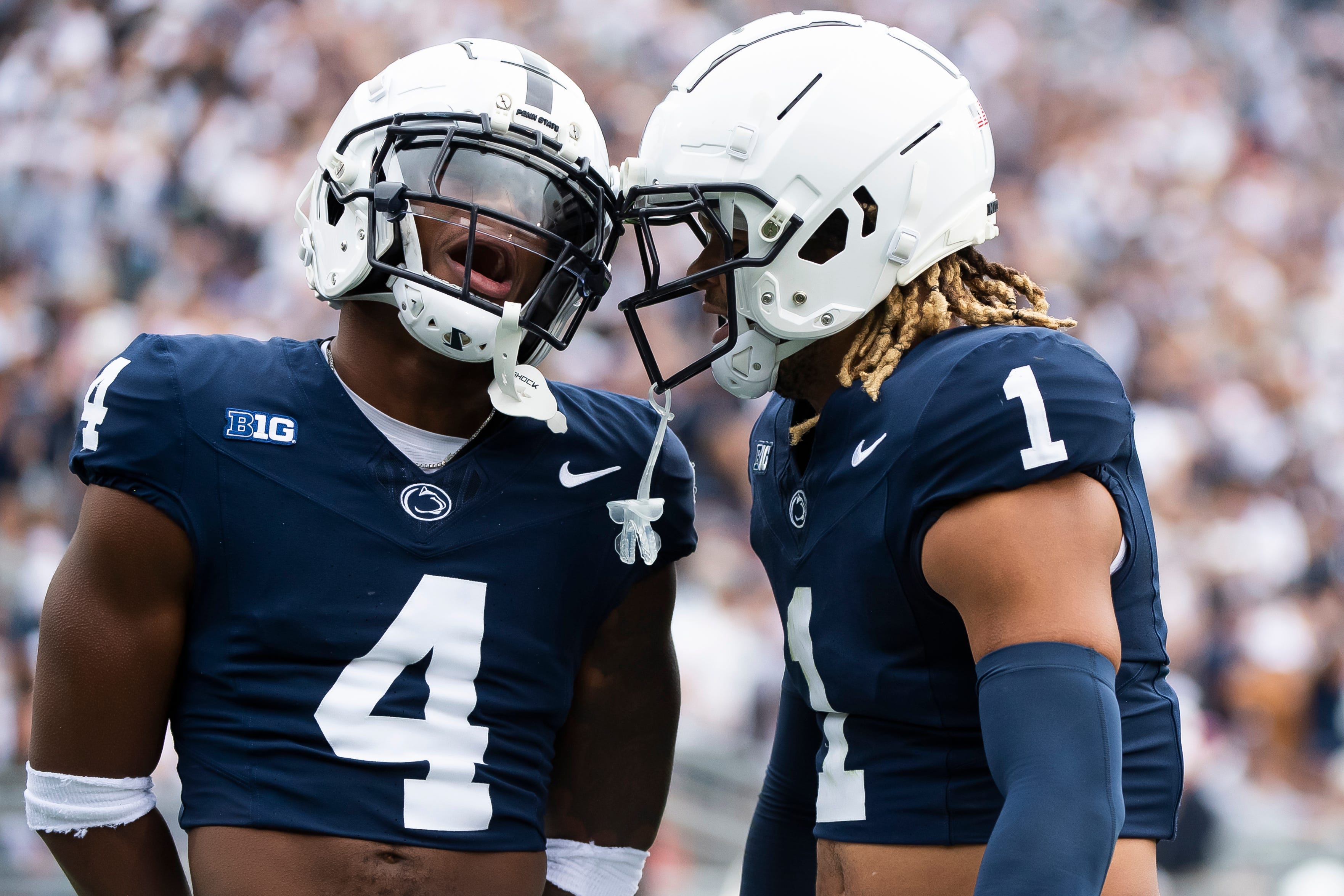 Penn State cornerback Kalen King (4) celebrates with safety Jaylen Reed (1) after Reed intercepted a pass in the first half of an NCAA football game against Indiana Saturday, Oct. 28, 2023, in State College, Pa. The Nittany Lions won, 33-24.