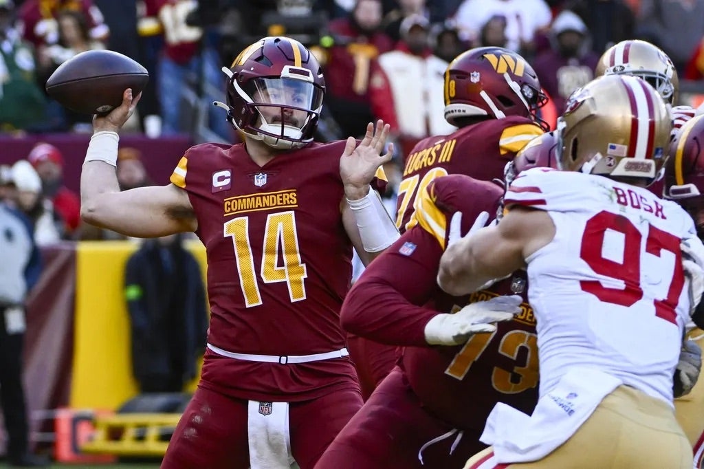 Washington Commanders quarterback Sam Howell (14) attempts a pass against the San Francisco 49ers during the second half at FedExField.