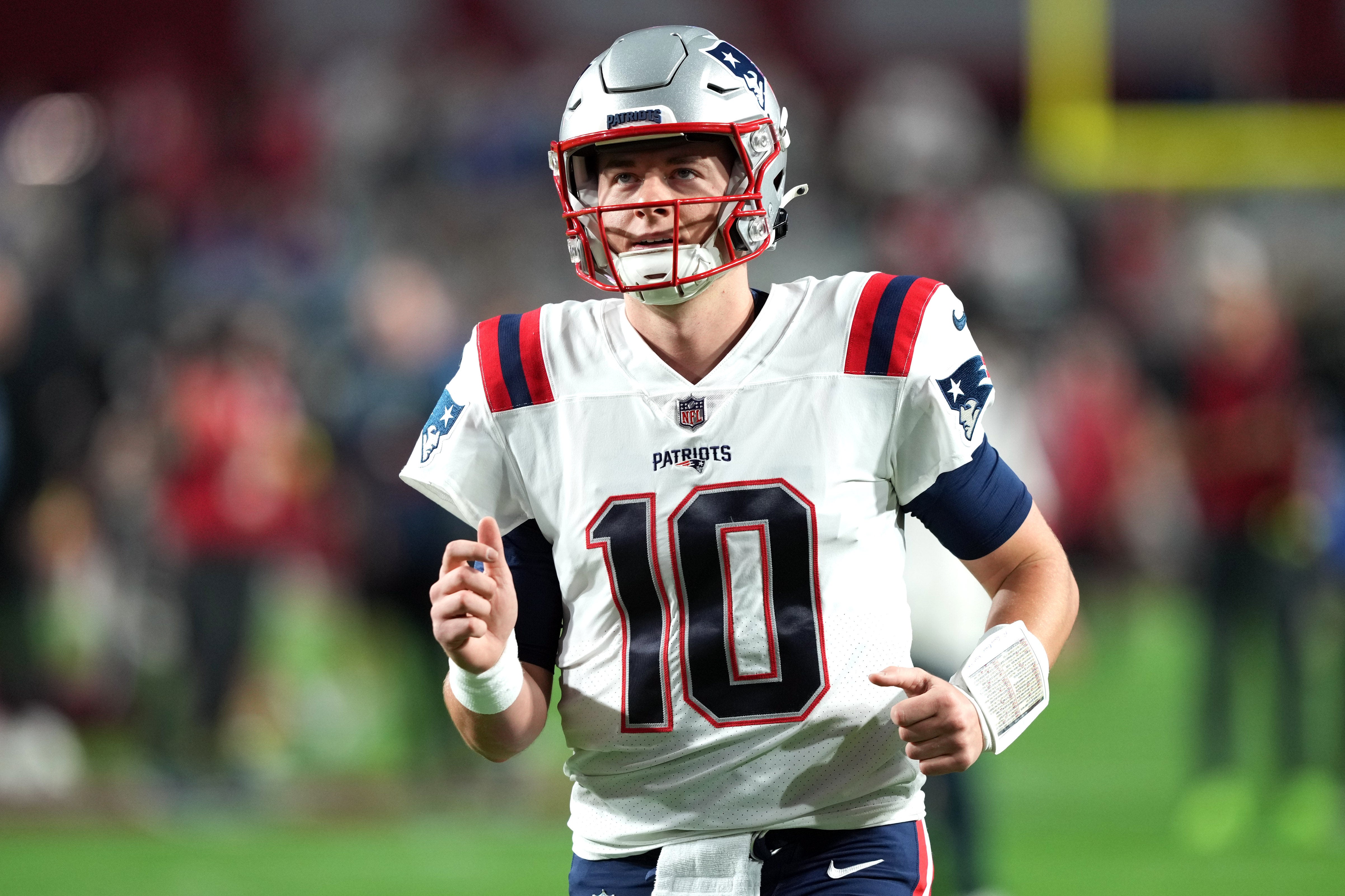 New England Patriots quarterback Mac Jones warms up prior to facing the Arizona Cardinals at State Farm Stadium.