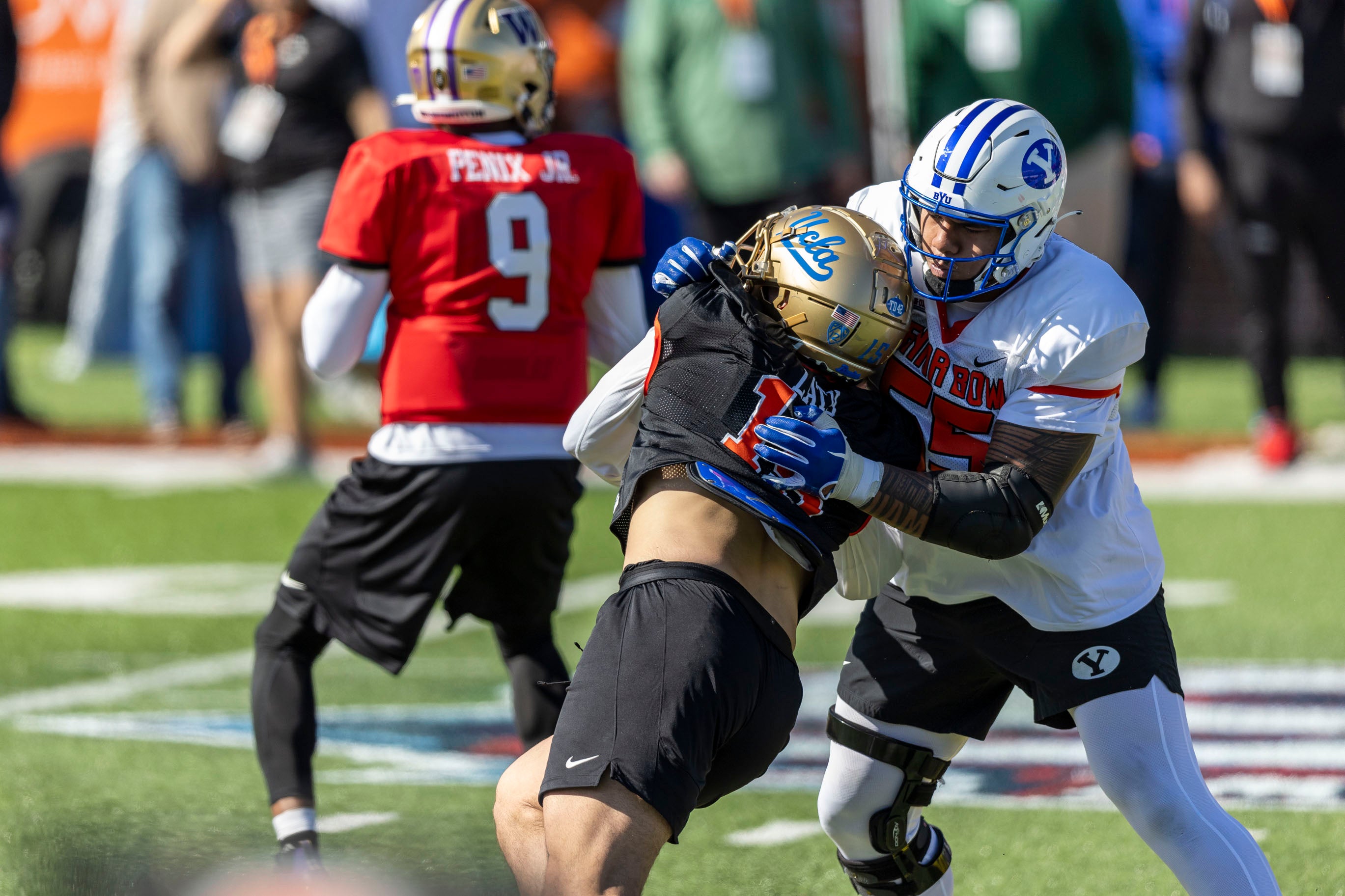 Jan 30, 2024; Mobile, AL, USA; National offensive lineman Kingsley Suamataia of Byu (55) battles National edge Laiatu Latu of Ucla (15) during practice for the National team at Hancock Whitney Stadium.