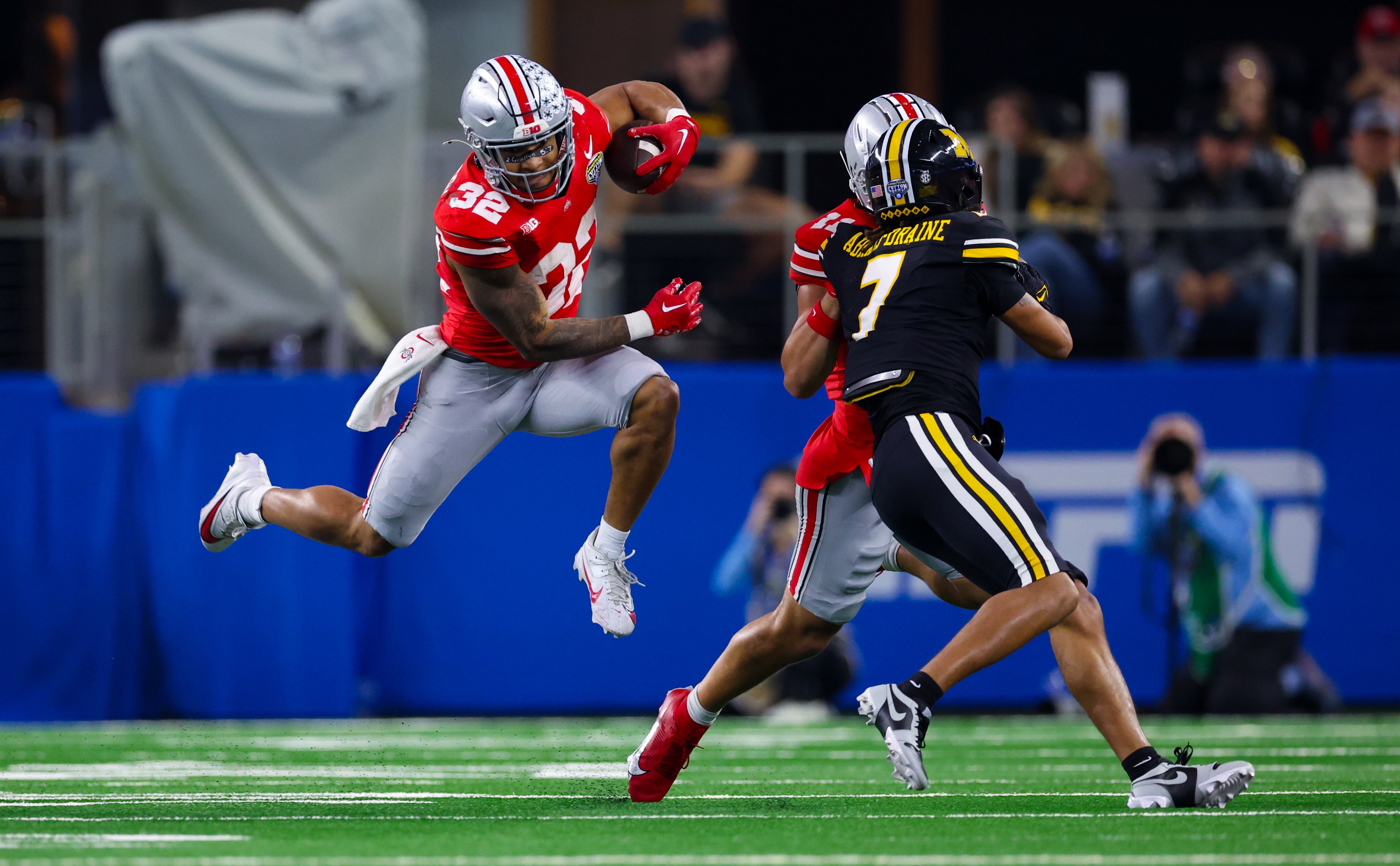 Dec 29, 2023; Arlington, TX, USA; Ohio State Buckeyes running back TreVeyon Henderson (32) runs with the ball as Missouri Tigers defensive back Kris Abrams-Draine (7) defends during the second half at AT&T Stadium. Mandatory Credit: Kevin Jairaj-USA TODAY Sports