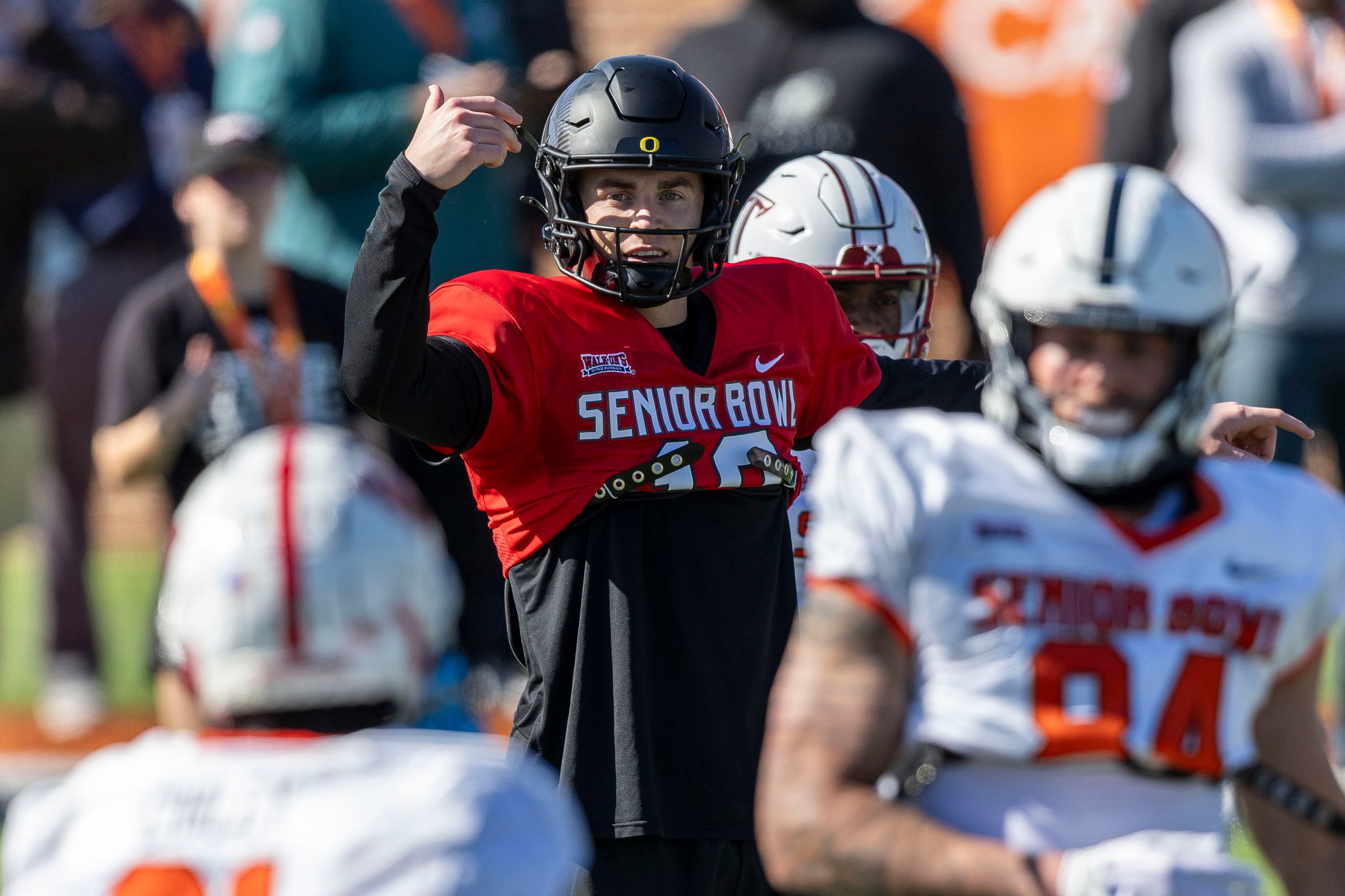 Jan 30, 2024; Mobile, AL, USA; National quarterback Bo Nix of Oregon (10) sets the offense during practice for the National team at Hancock Whitney Stadium.