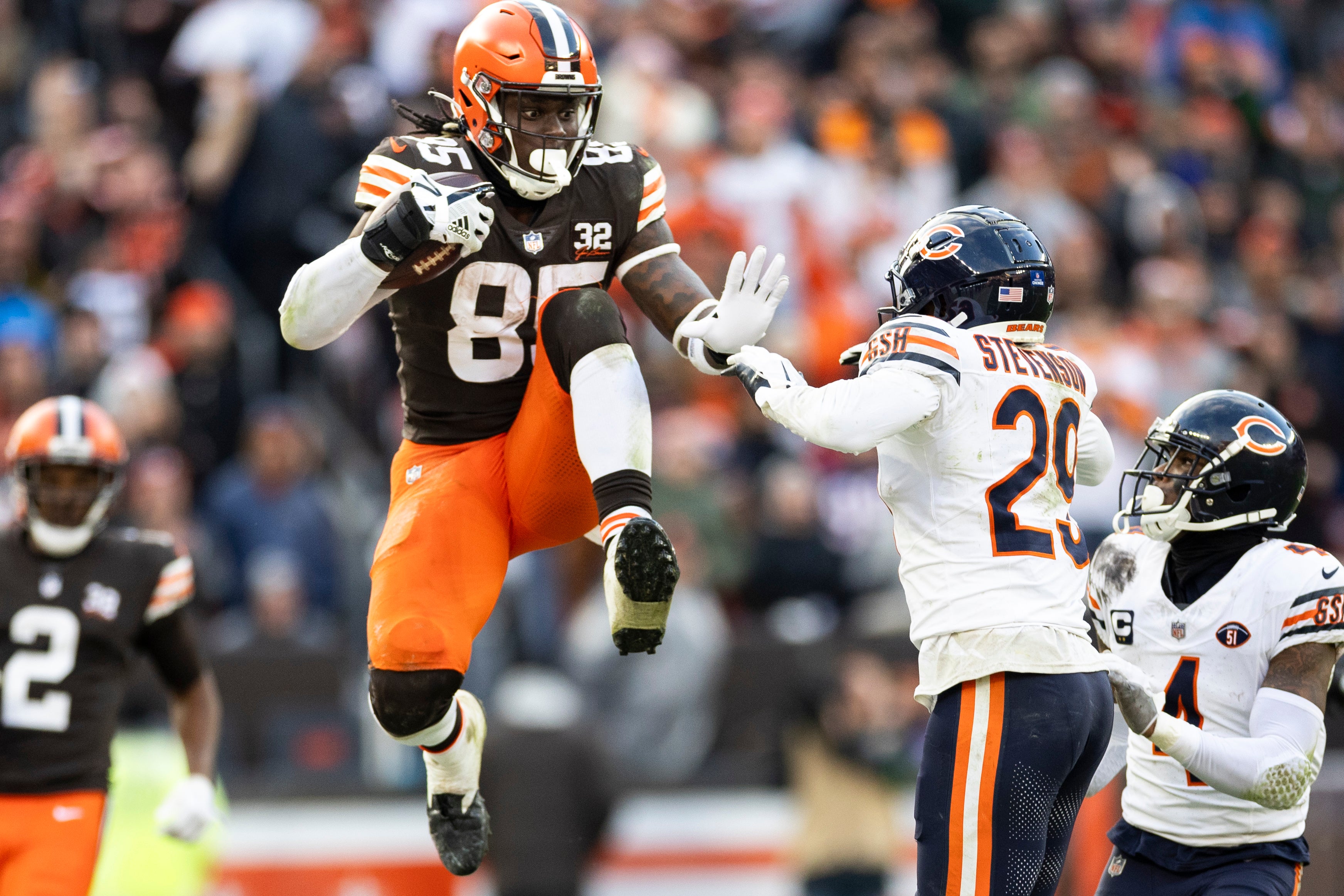 Dec 17, 2023; Cleveland, Ohio, USA; Cleveland Browns tight end David Njoku (85) leaps to avoid a tackle by Chicago Bears cornerback Tyrique Stevenson (29) during the fourth quarter at Cleveland Browns Stadium. Mandatory Credit: Scott Galvin-USA TODAY Sports