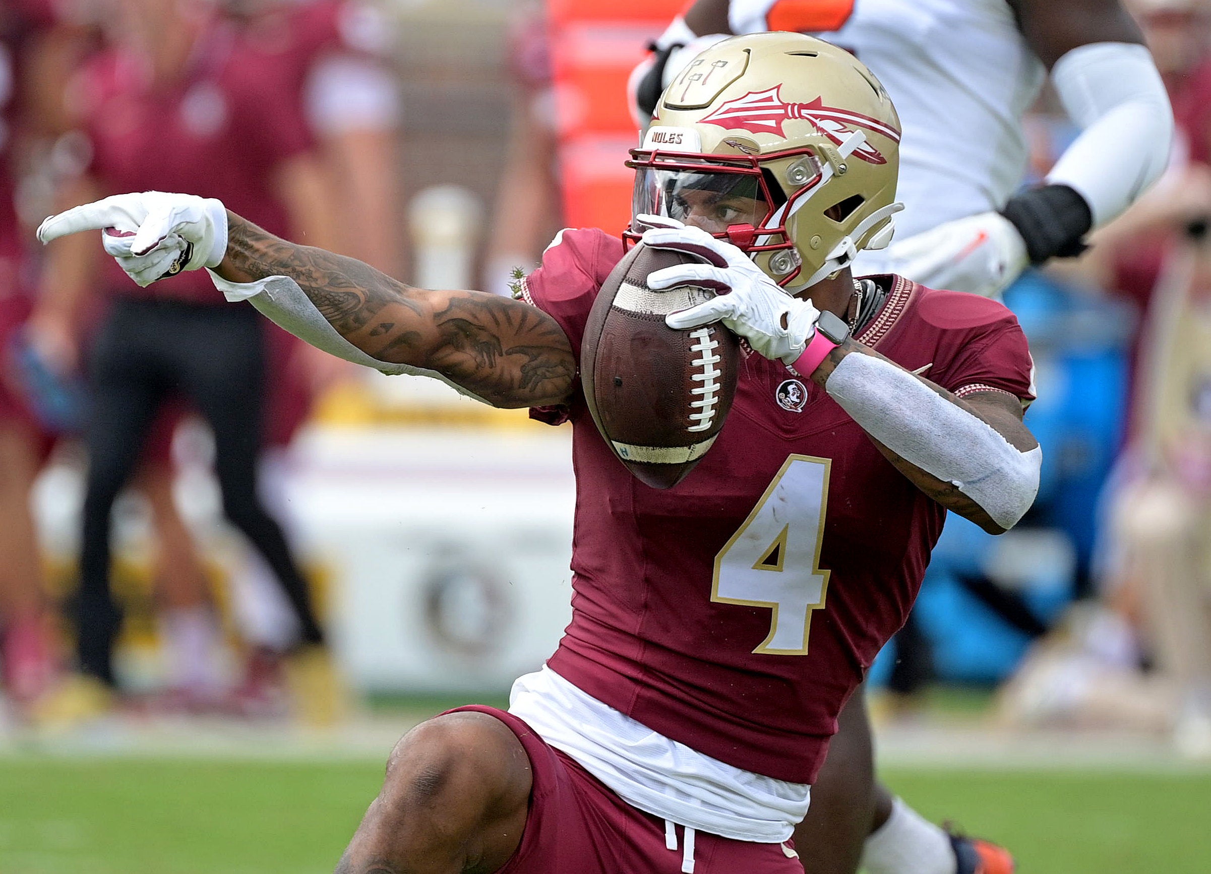 Oct 14, 2023; Tallahassee, Florida, USA; Florida State Seminoles wide receiver Keon Coleman (4) celebrates after catching a pass over Syracuse Orange defensive back Jason Simmons Jr. (6) (not pictured) during the first quarter at Doak S. Campbell Stadium.