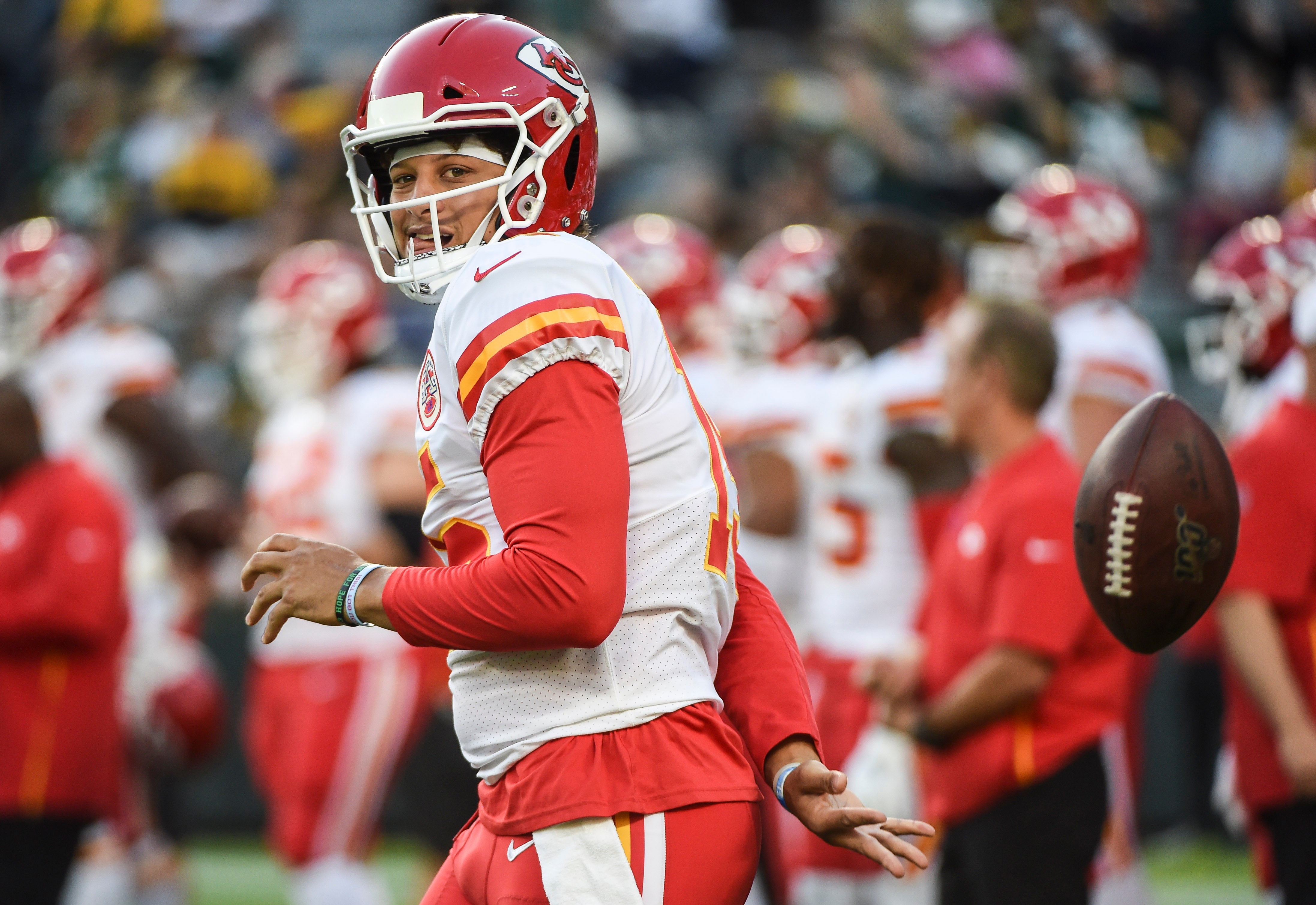 Aug 29, 2019; Green Bay, WI, USA; Kansas City Chiefs quarterback Patrick Mahomes (15) flips the ball behind his back during warmups before game against the Green Bay Packers at Lambeau Field. Mandatory Credit: Benny Sieu-USA TODAY Sports  
