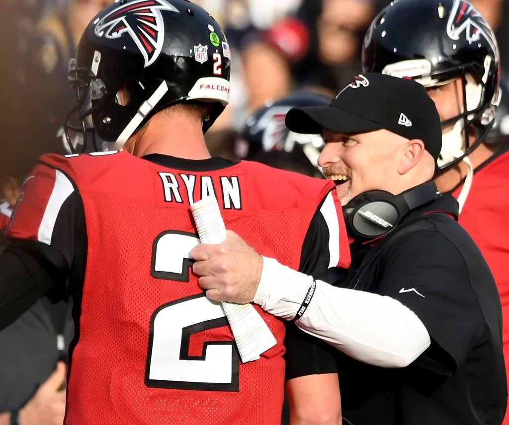 Atlanta Falcons quarterback Matt Ryan (2) is congratulated by Atlanta Falcons head coach Dan Quinn after a touch down in the third quarter of the game against the Los Angeles Rams.