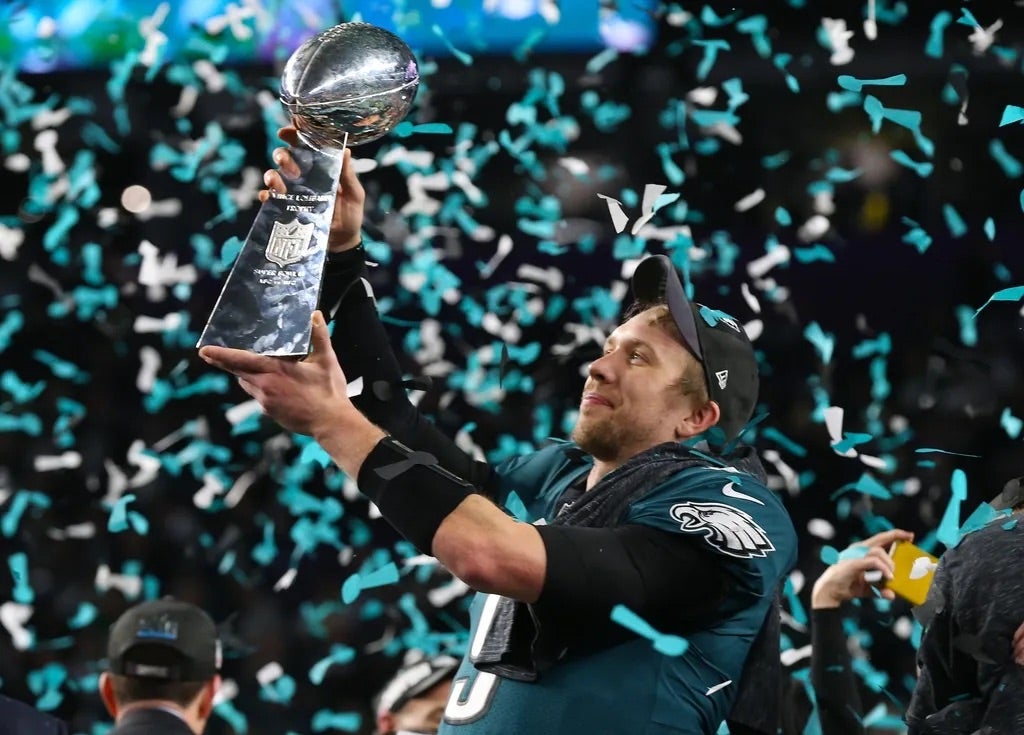 Philadelphia Eagles quarterback Nick Foles (9) hoist the Vince Lombardi Trophy after a victory against the New England Patriots in Super Bowl LII at U.S. Bank Stadium.