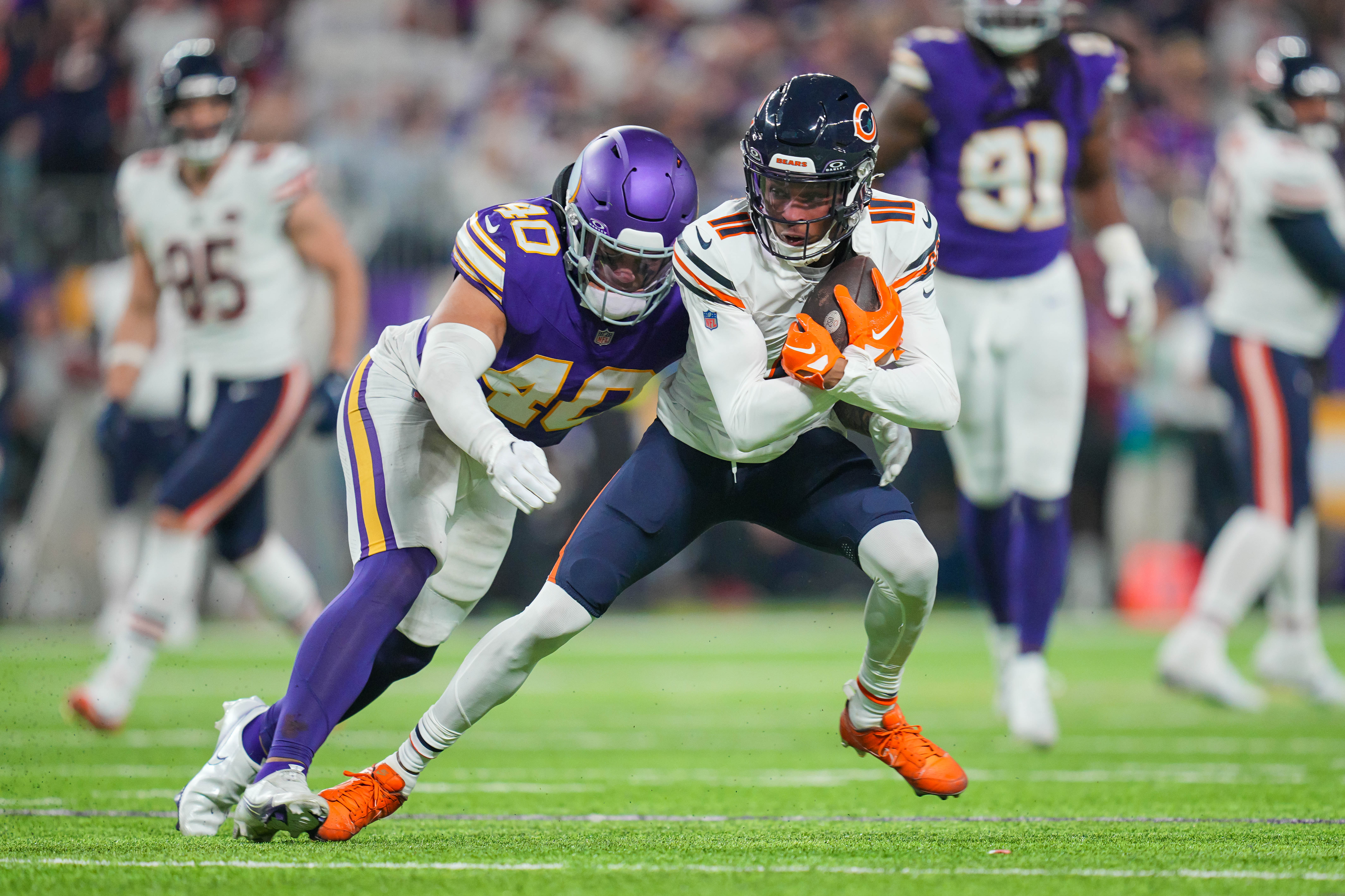 Nov 27, 2023; Minneapolis, Minnesota, USA; Chicago Bears wide receiver Darnell Mooney (11) runs after the catch against the Minnesota Vikings linebacker Ivan Pace Jr. (40) in the fourth quarter at U.S. Bank Stadium.