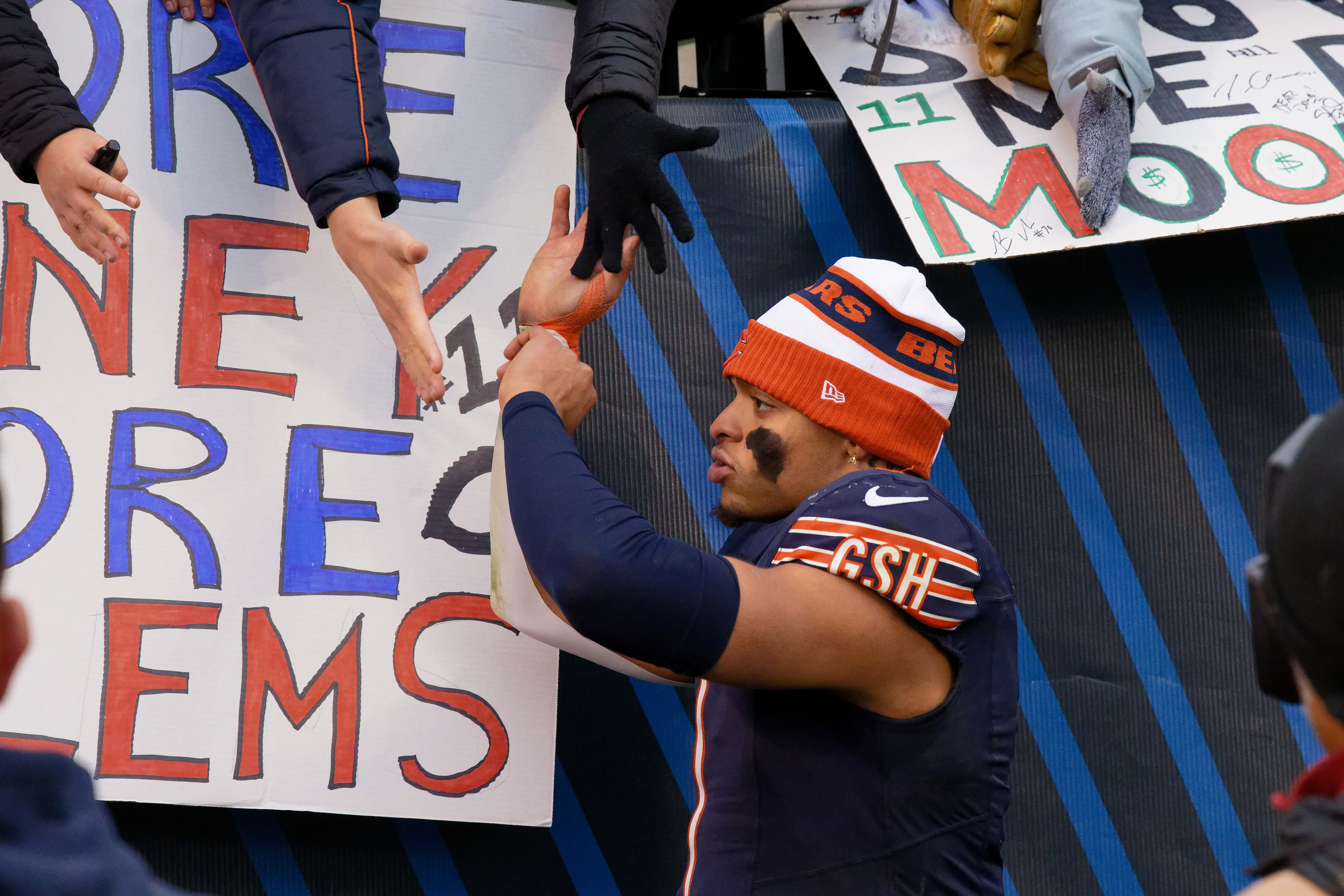 Dec 10, 2023; Chicago, Illinois, USA; Chicago Bears quarterback Justin Fields (1) greets fans after a game against the Detroit Lions at Soldier Field.
