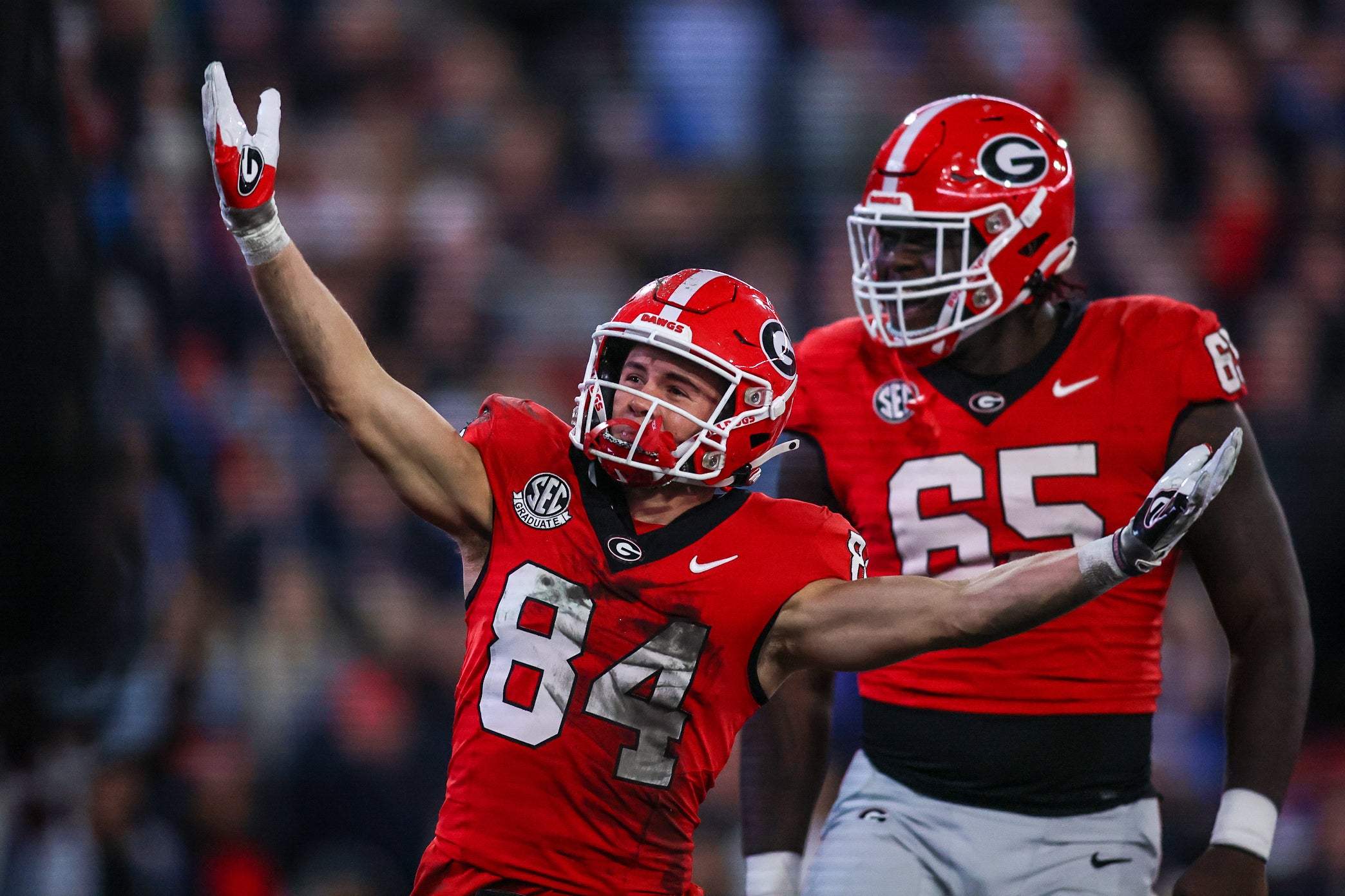 Nov 11, 2023; Athens, Georgia, USA; Georgia Bulldogs wide receiver Ladd McConkey (84) celebrates after a touchdown with offensive lineman Amarius Mims (65) against the Mississippi Rebels in the first quarter at Sanford Stadium. Mandatory Credit: Brett Davis-USA TODAY Sports