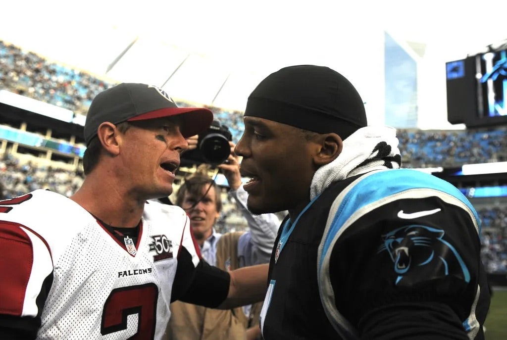 Carolina Panthers quarterback Cam Newton (1) and quarterback Matt Ryan (2) talk after the game at Bank of America Stadium. Panthers win 38-0.