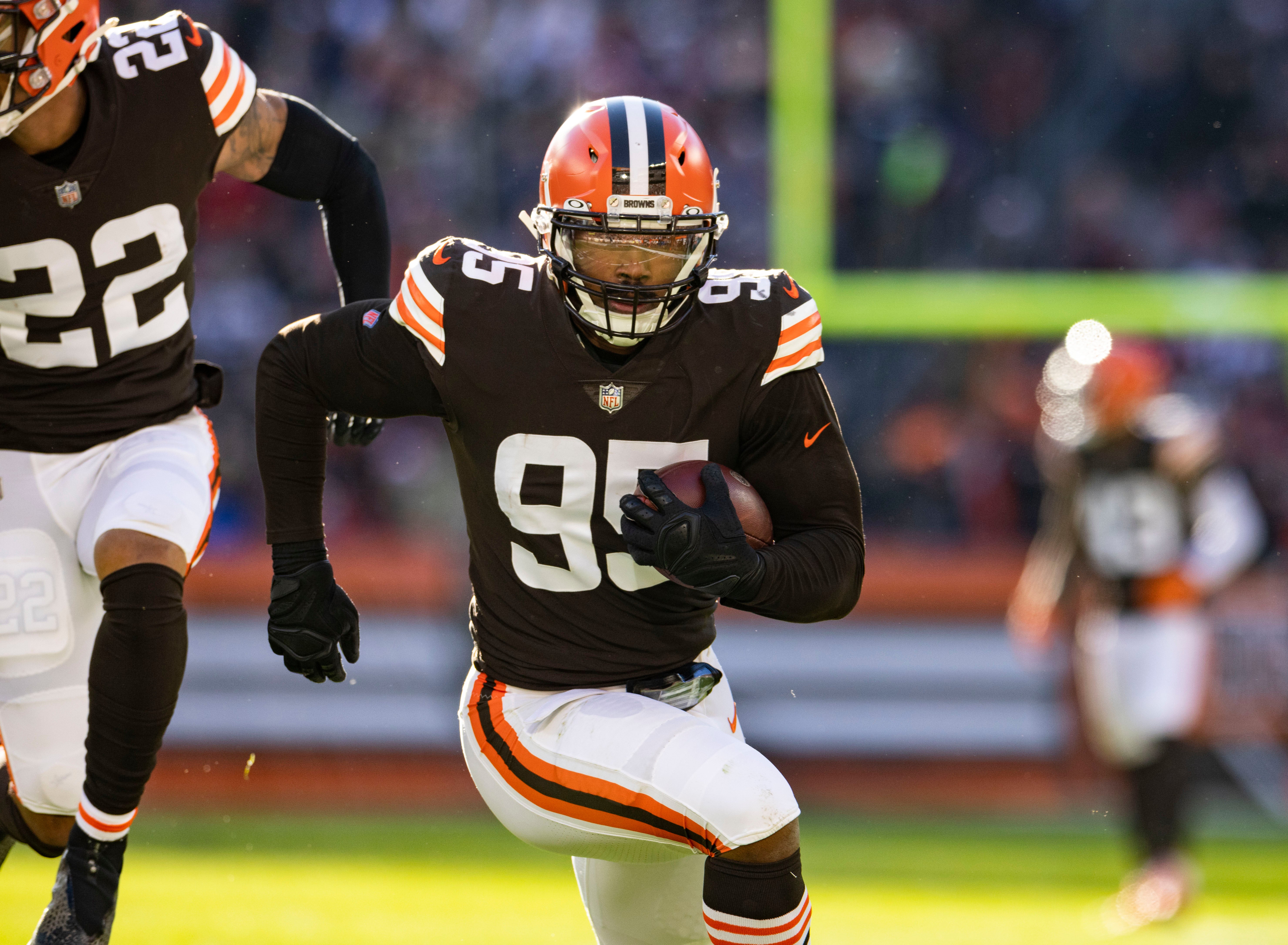 Dec 12, 2021; Cleveland, Ohio, USA; Cleveland Browns defensive end Myles Garrett (95) returns a fumble for a touchdown against the Baltimore Ravens during the second quarter at FirstEnergy Stadium. Mandatory Credit: Scott Galvin-USA TODAY Sports