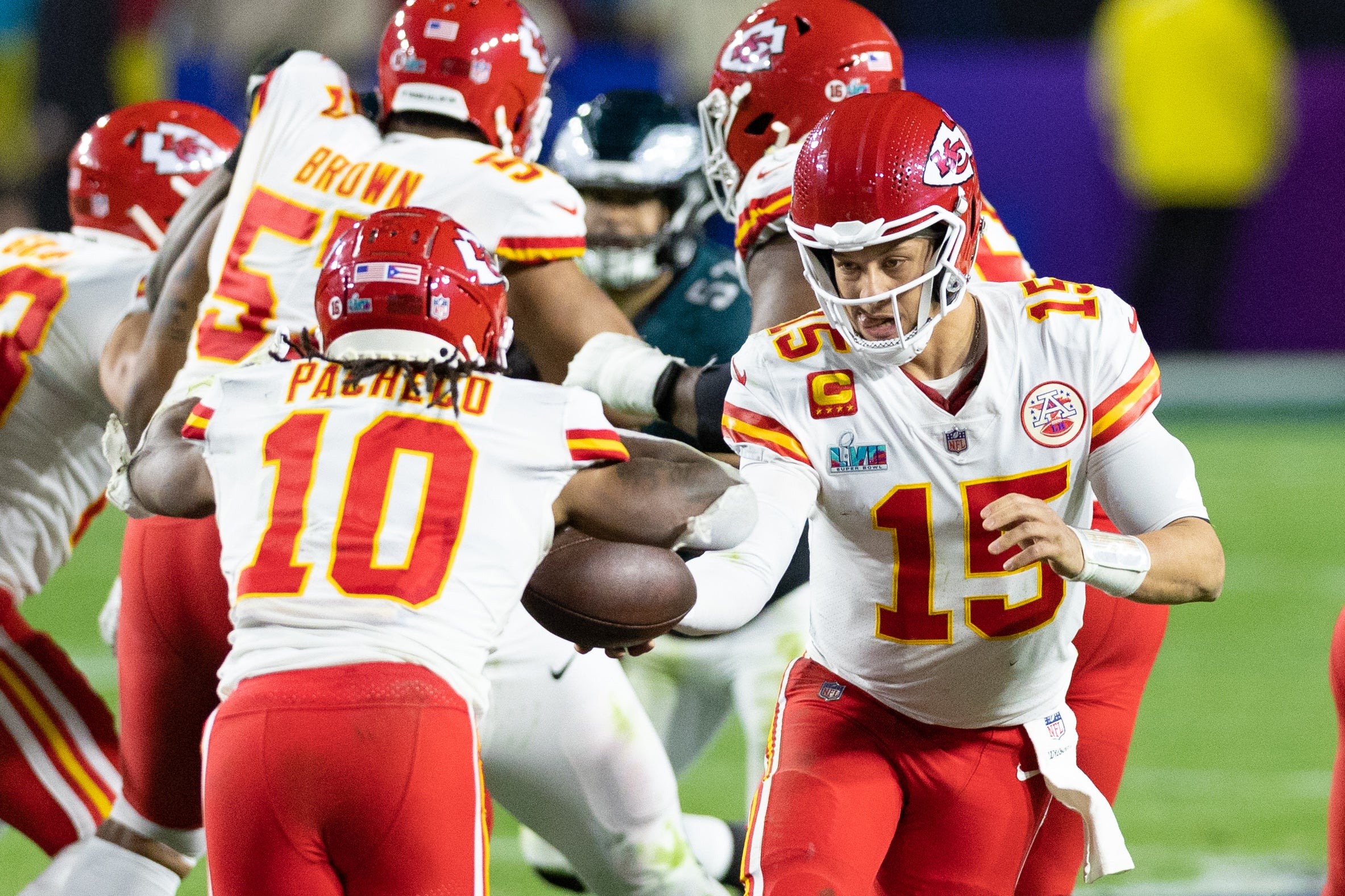 Kansas City Chiefs quarterback Patrick Mahomes (15) hands off to running back Isiah Pacheco (10) against the Philadelphia Eagles in Super Bowl LVII at State Farm Stadium.