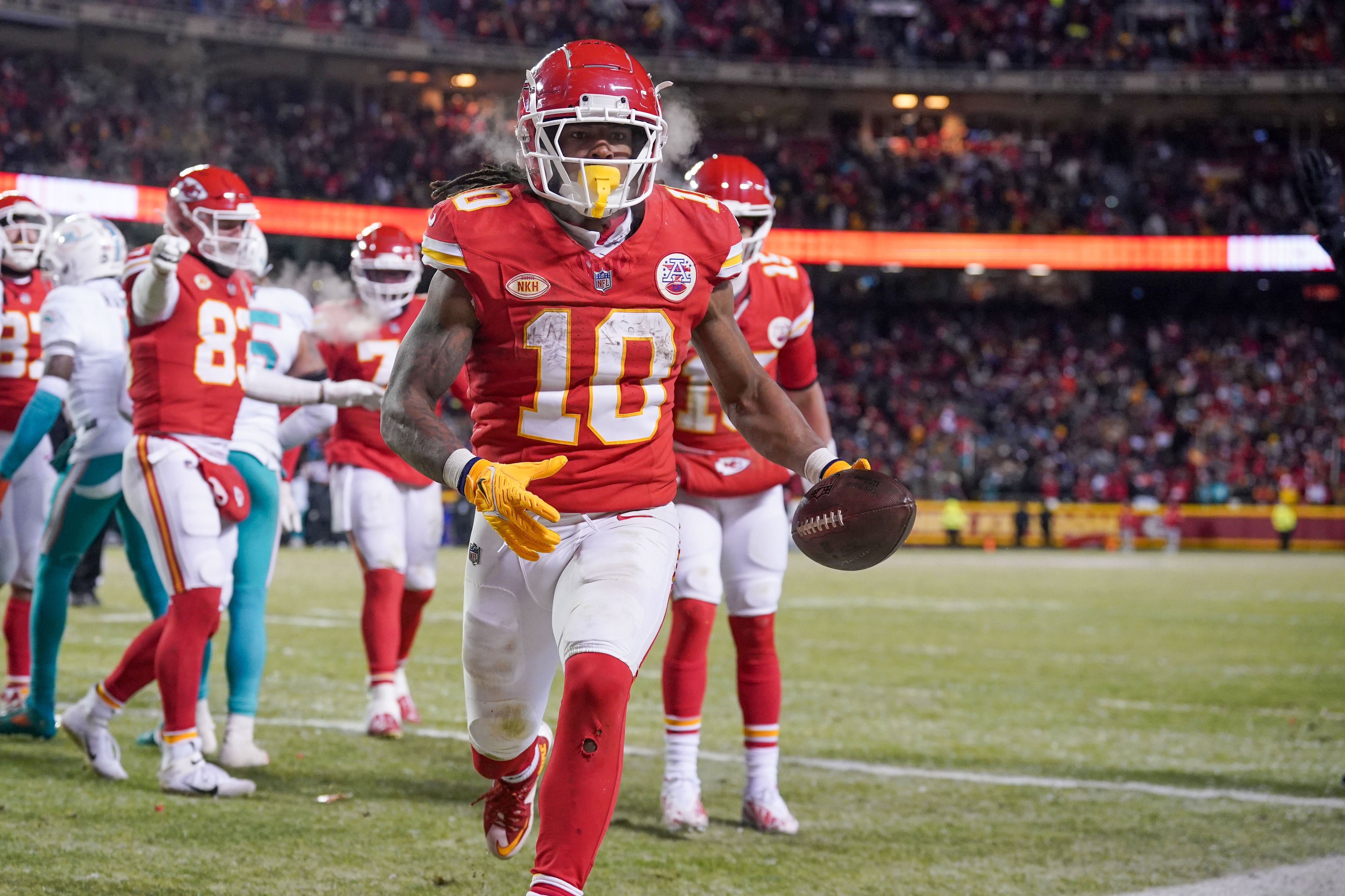 Kansas City Chiefs running back Isiah Pacheco (10) runs toward the fans after scoring against the Miami Dolphins in a 2024 AFC wild-card game