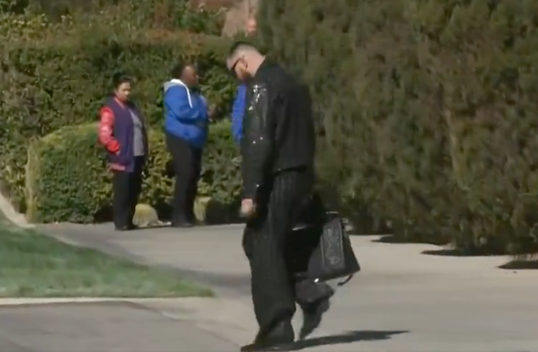 Travis Kelce arrives in a sparkly black outfit ahead of Super Bowl LVIII