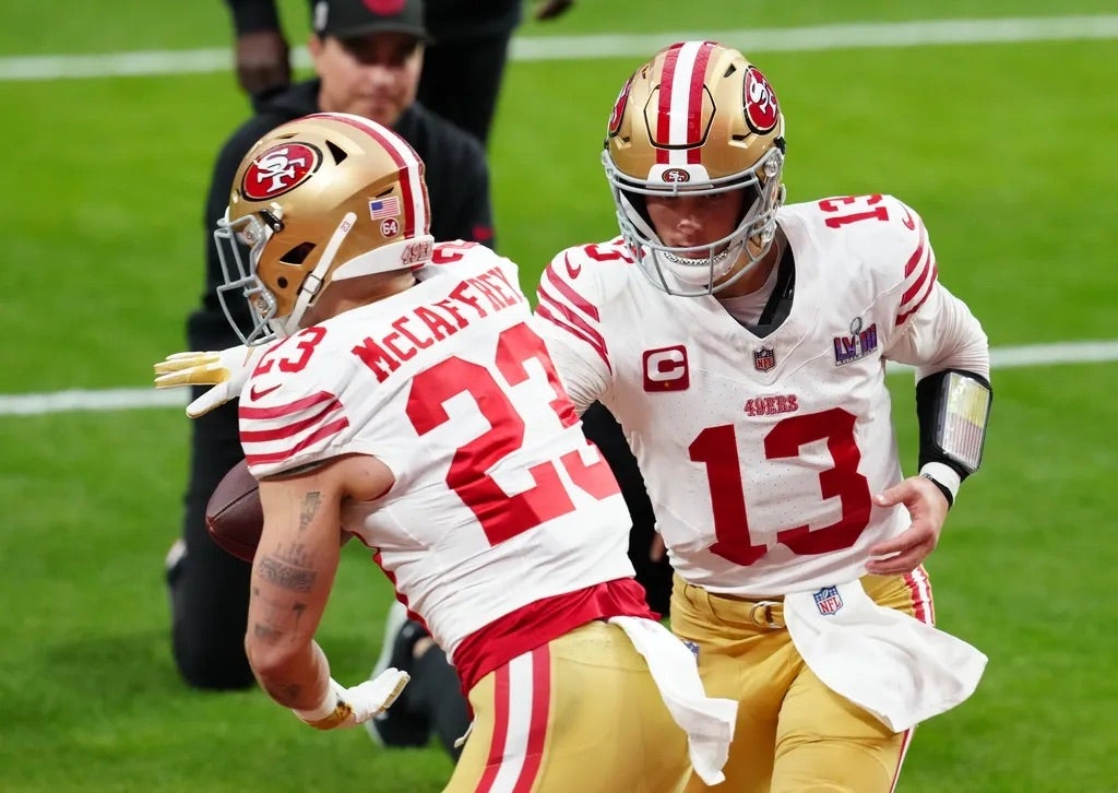 San Francisco 49ers quarterback Brock Purdy (13) hands off to San Francisco 49ers running back Christian McCaffrey (23) as they warm up before playing the Kansas City Chiefs in Super Bowl LVIII